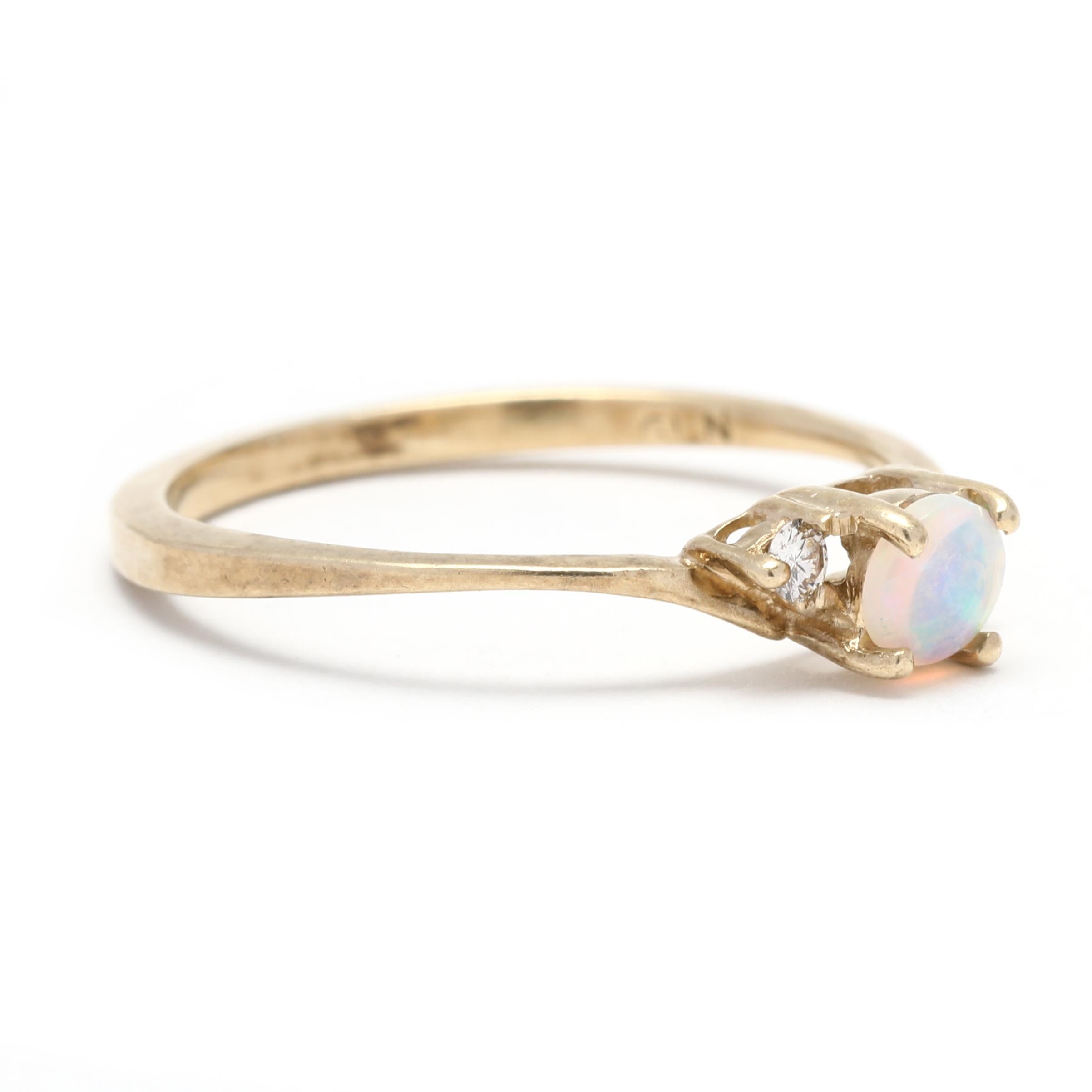 This 0.20ctw Opal Diamond Ring will make a special addition to any jewelry collection. Crafted in 10K yellow gold, this beautiful ring features a petite opal stone surrounded by a halo of sparkling diamonds. The bypass design of this small opal ring