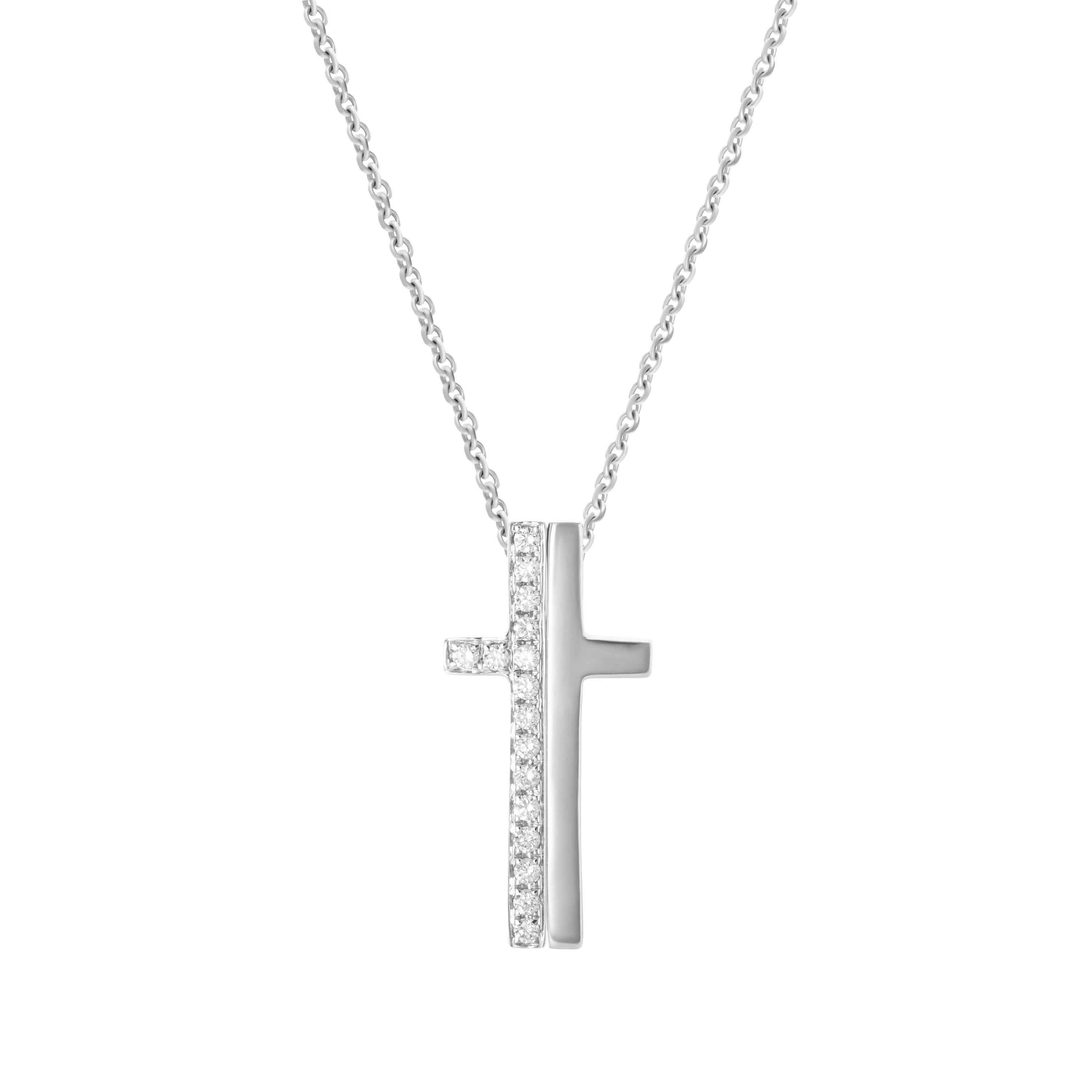 18-karat white gold necklace features a split cross - one side in solid gold, the other accented by 0.21 carats of round brilliant cut diamonds.  Chain length 18 inches.  Pendant height 2.5cm, pendant width 1.3cm. 

Composition:
18K White Gold
16