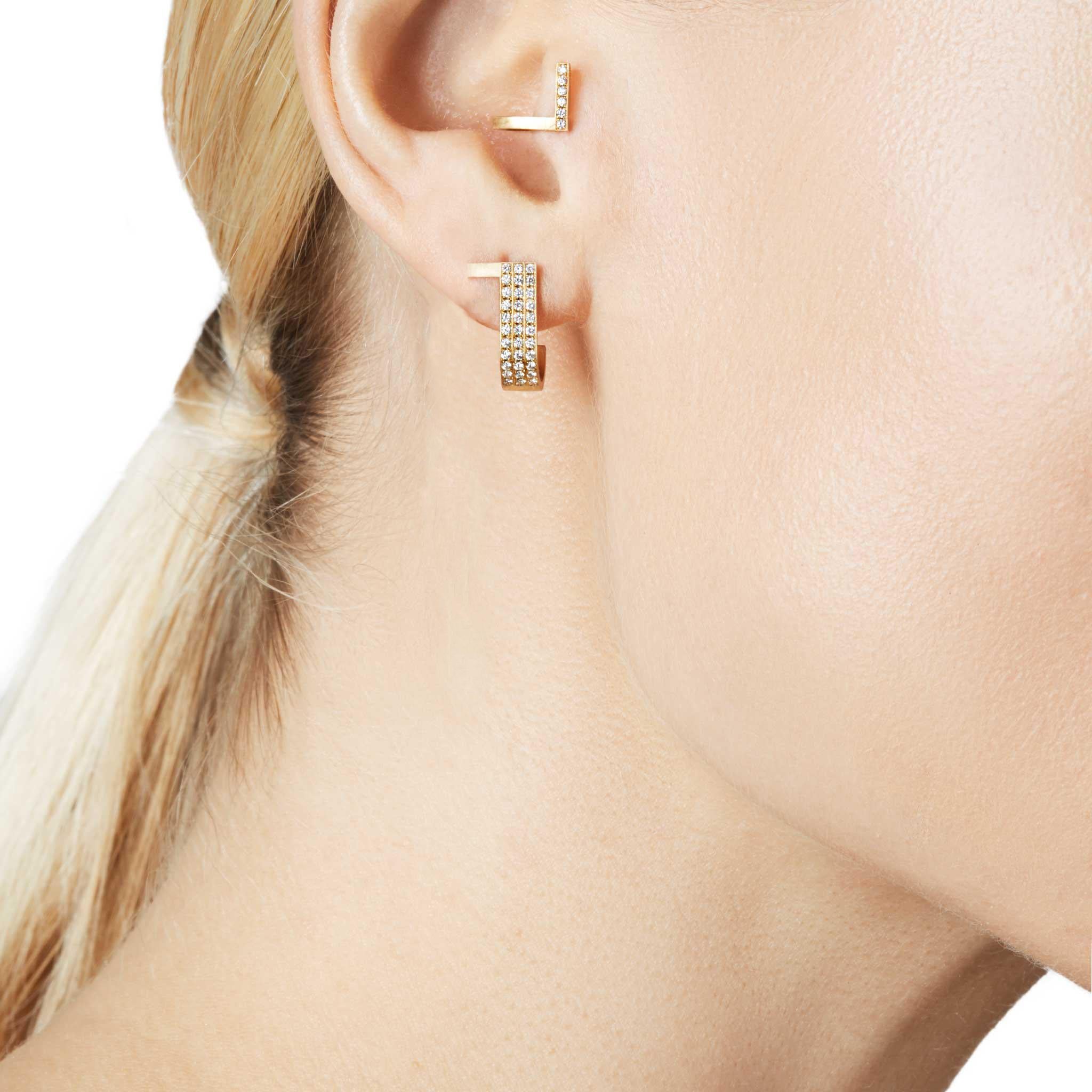 Unfinishing Line collection exudes minimalism and precision with its smooth lines and angles. Detailed with a curved structure and matt brushed finish. 18-Karat Yellow Gold Long extension Earring is perfect for day to night wear due to the