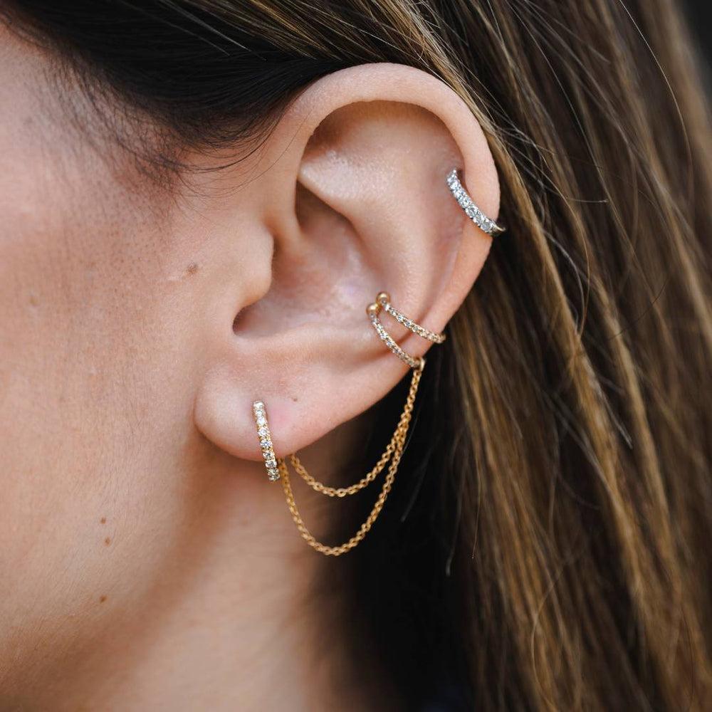 0.22 Carat Genuine Diamond Double Chain Helix Ear Cuff in 14K Yellow Gold

Give your look a modern edge with this unique ear cuff. Connected by two 14k yellow gold dainty chains, the double hoop design is embellished with 36 sparkling diamonds