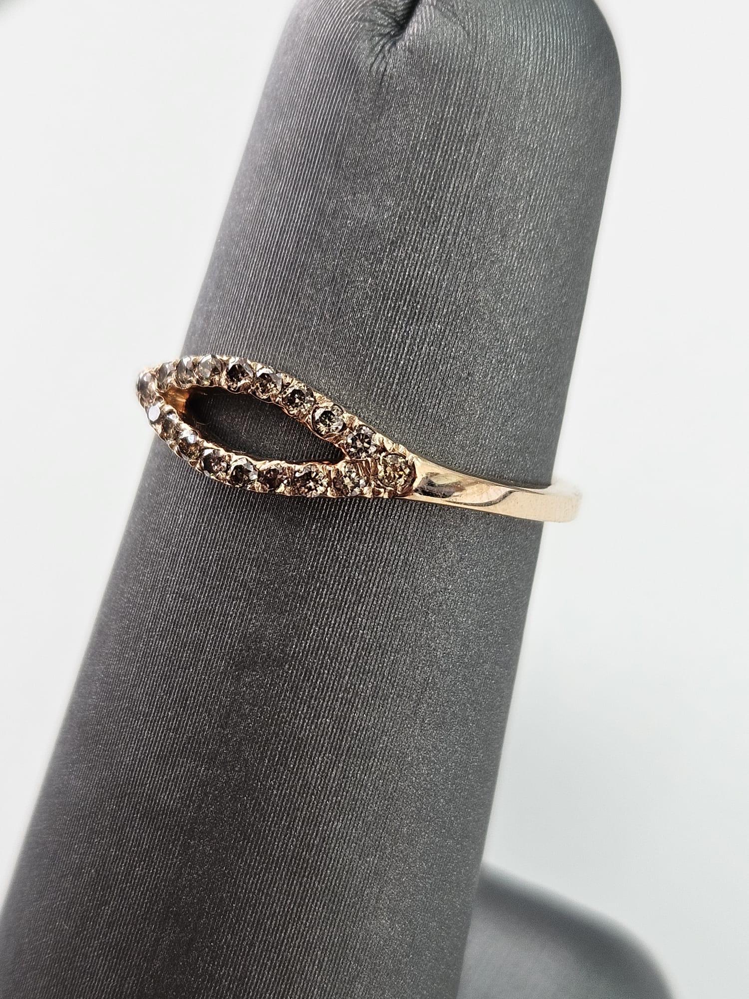 Wir präsentieren einen faszinierenden und eleganten ovalen Ring mit einem braunen Diamanten von 0,22 Karat, der sorgfältig in luxuriösem Roségold gefertigt wurde und Wärme und Raffinesse ausstrahlt. Dieser exquisite Ring zeichnet sich durch