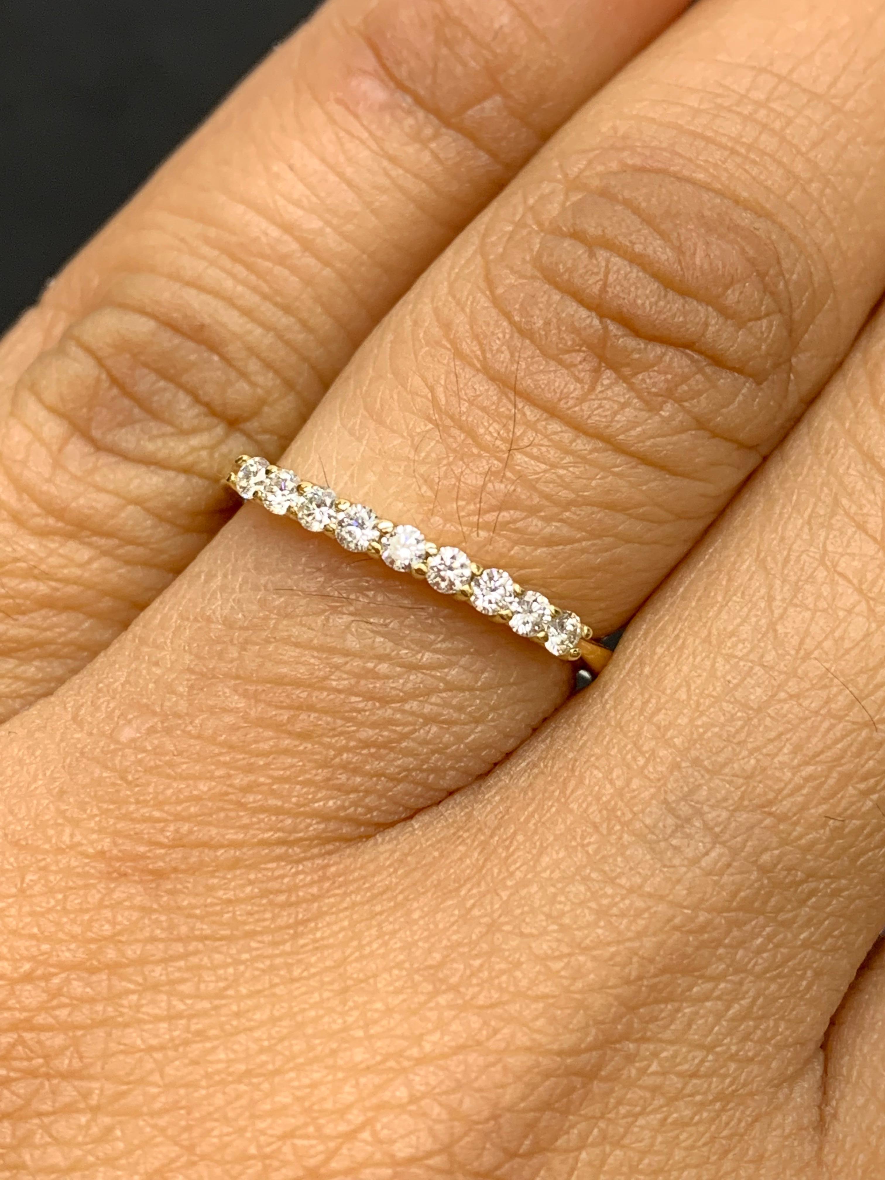 A fashionable and classic wedding band showcasing 9 brilliant cut diamonds weighing 0.23 carats total. Stones are secured with a shared prong setting made with 14 karats yellow gold. A versatile piece that can be worn as a fashionable right-hand