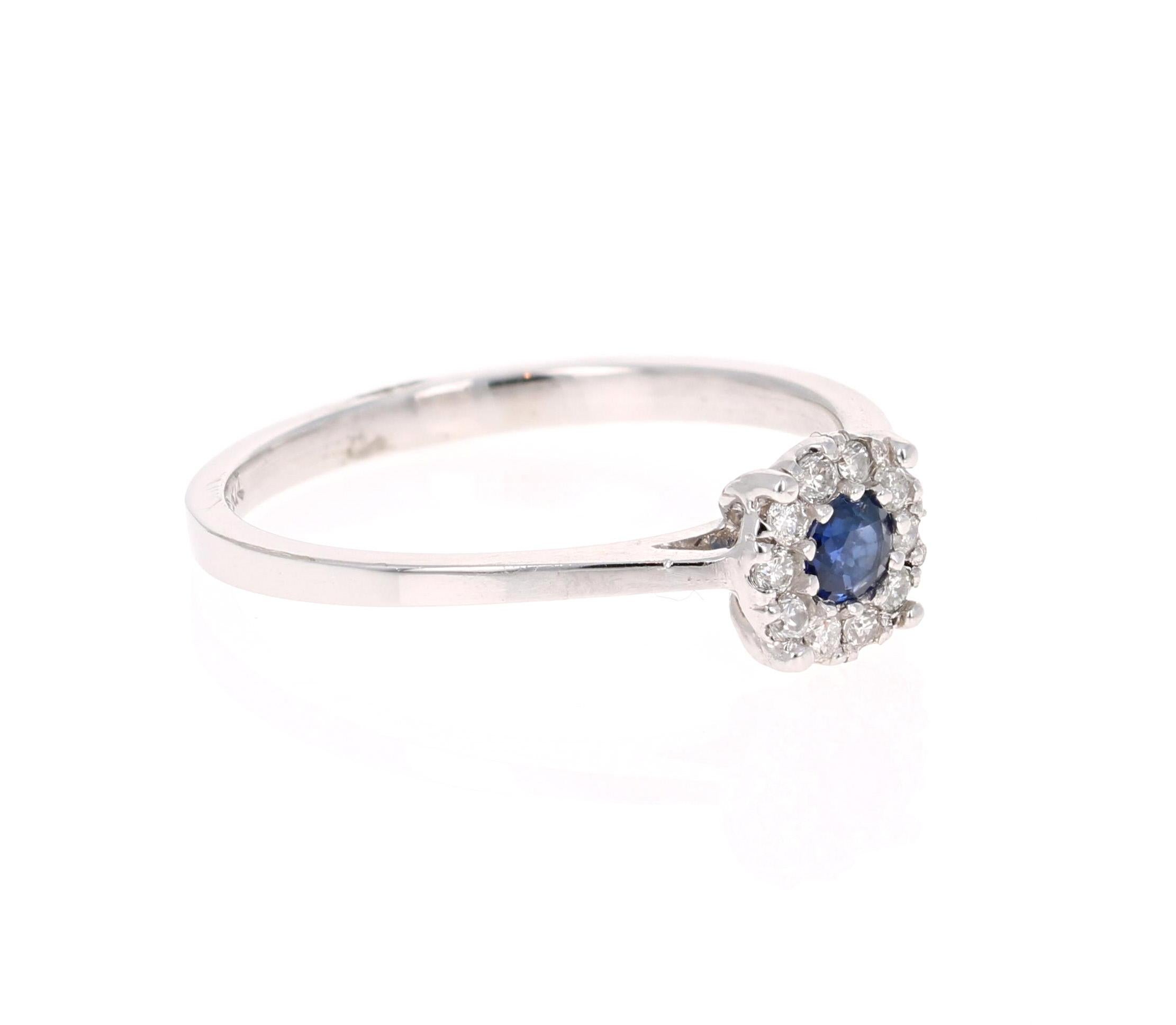 This delicate and dainty beauty has a Round Cut Blue Sapphire that weighs 0.12 Carats and has 10 Round Cut Diamonds that weighs 0.11 Carats. The total carat weight of the ring is 0.23 Carats. 

It is set in 14 Karat White Gold and weighs 1.9 grams.