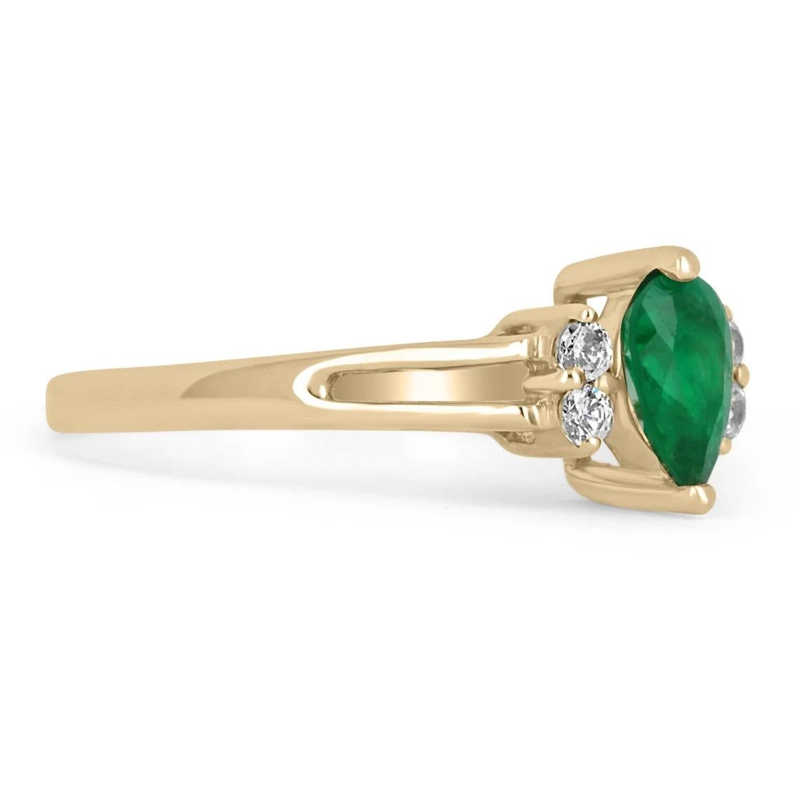 A simple, and petite emerald and diamond ring. The center stone is a 0.20-carat AAA+ Colombian emerald, pear-shaped. The center stone displays a stunning, vivacious dark green color and excellent luster. Two bright, brilliant round diamonds accent