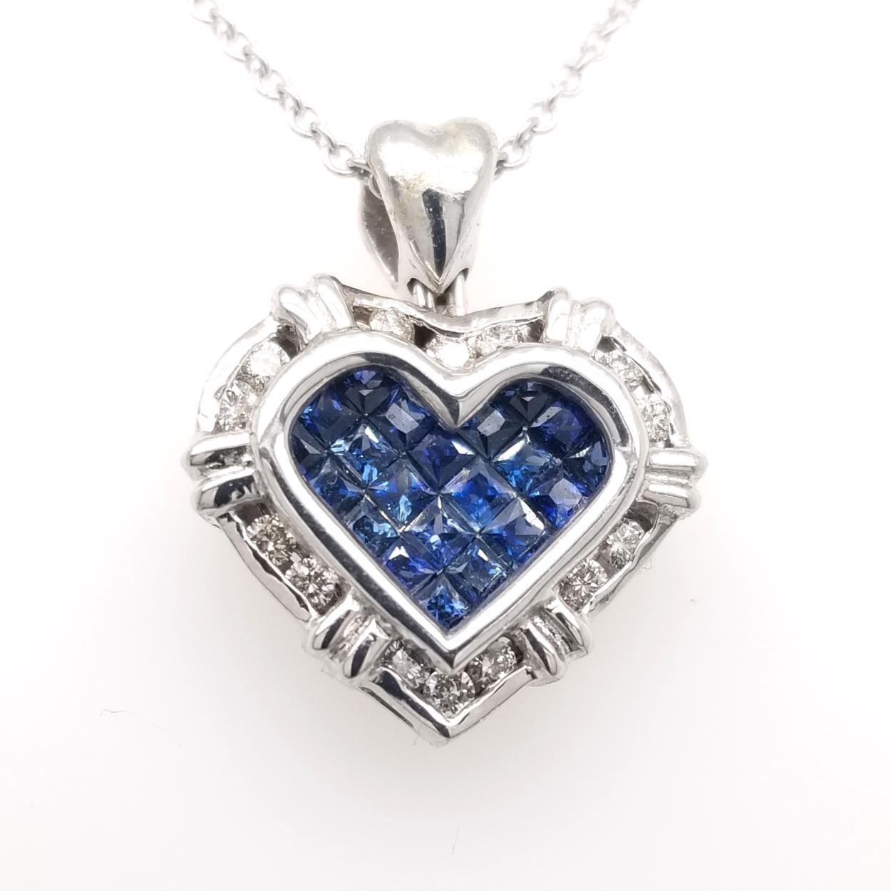 18K Gold Heart shaped Pendant with 21 Invisible Set Princess Cut Blue Sapphires (Total Gem Weight 0.75 Ct) surrounded by a Channel set Halo of diamonds with total weight of 0.24 Ct. 
Total Diamond Weight: 0.24 Ct
Total Gem Weight: 0.75 Ct
Total