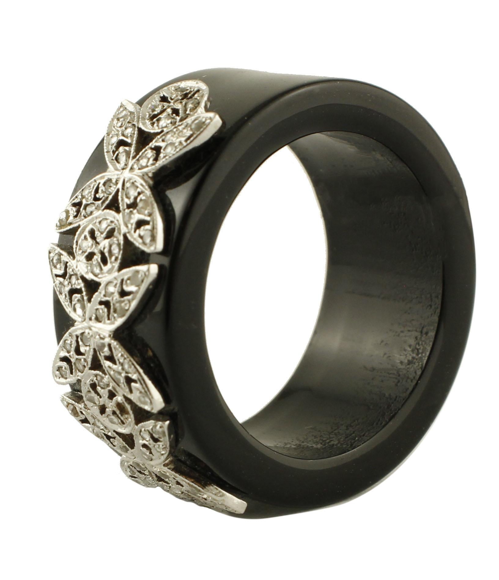 Unique onyx band ring adorned with 14K white gold butterfly detailes studded with 0.24 ct of little diamonds.
Diamonds 0.24 ct
Onyx 5.9 g
Total Weight 7.80 g
R.F + rea
Ring Dimention 26 mm X 11 mm 
Italian size 20
French size 60
Usa size 9.17

For