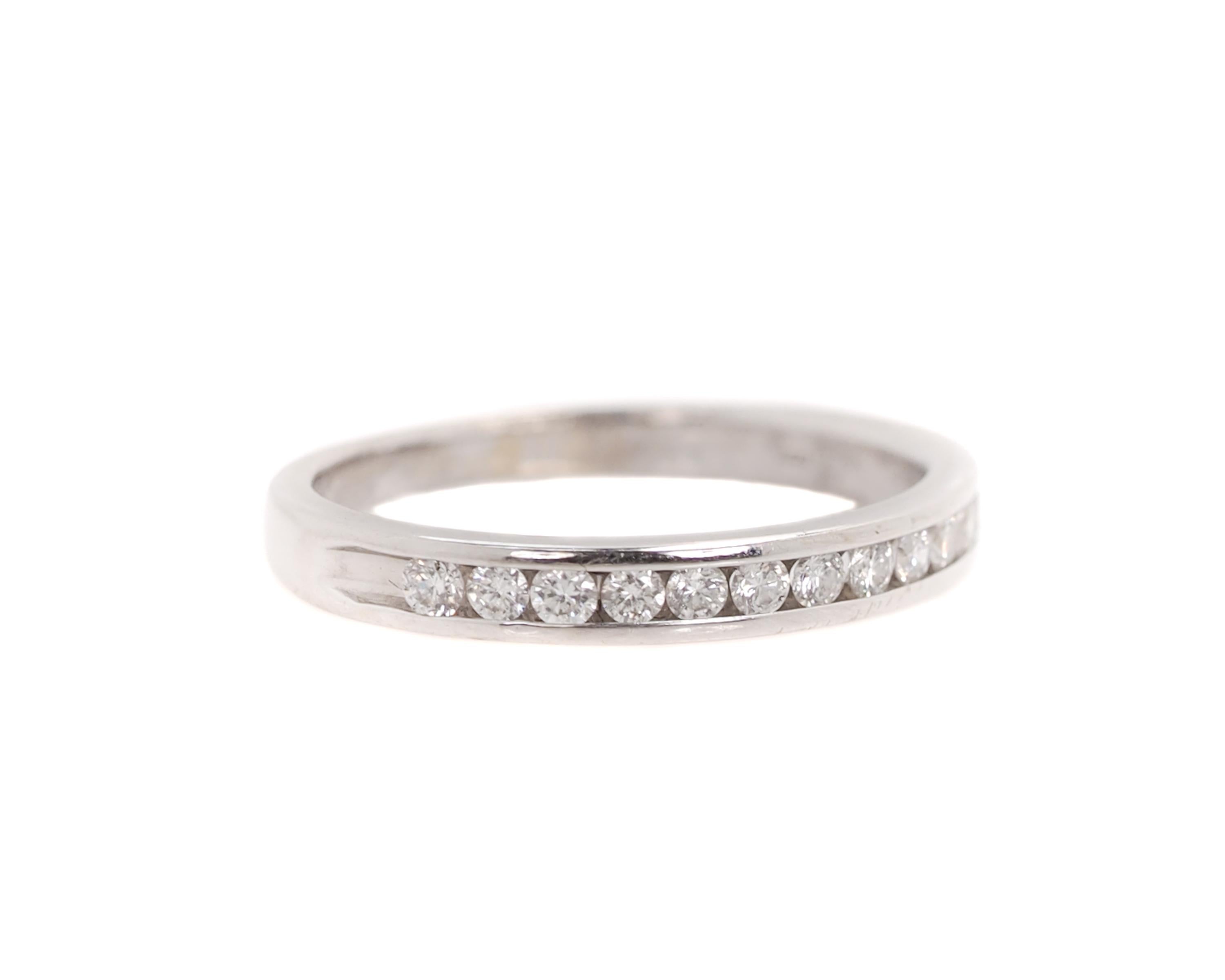 New Halfway Around Eternity Band Wedding Ring 

Features 12 Diamonds channel set in a 14 karat White Gold band. 

The finger to top of ring measures 1.5 millimeters. 
The shank tapers from 2.6 - 1.8 millimeters.

Ring Details:
Metal Type: 14k White