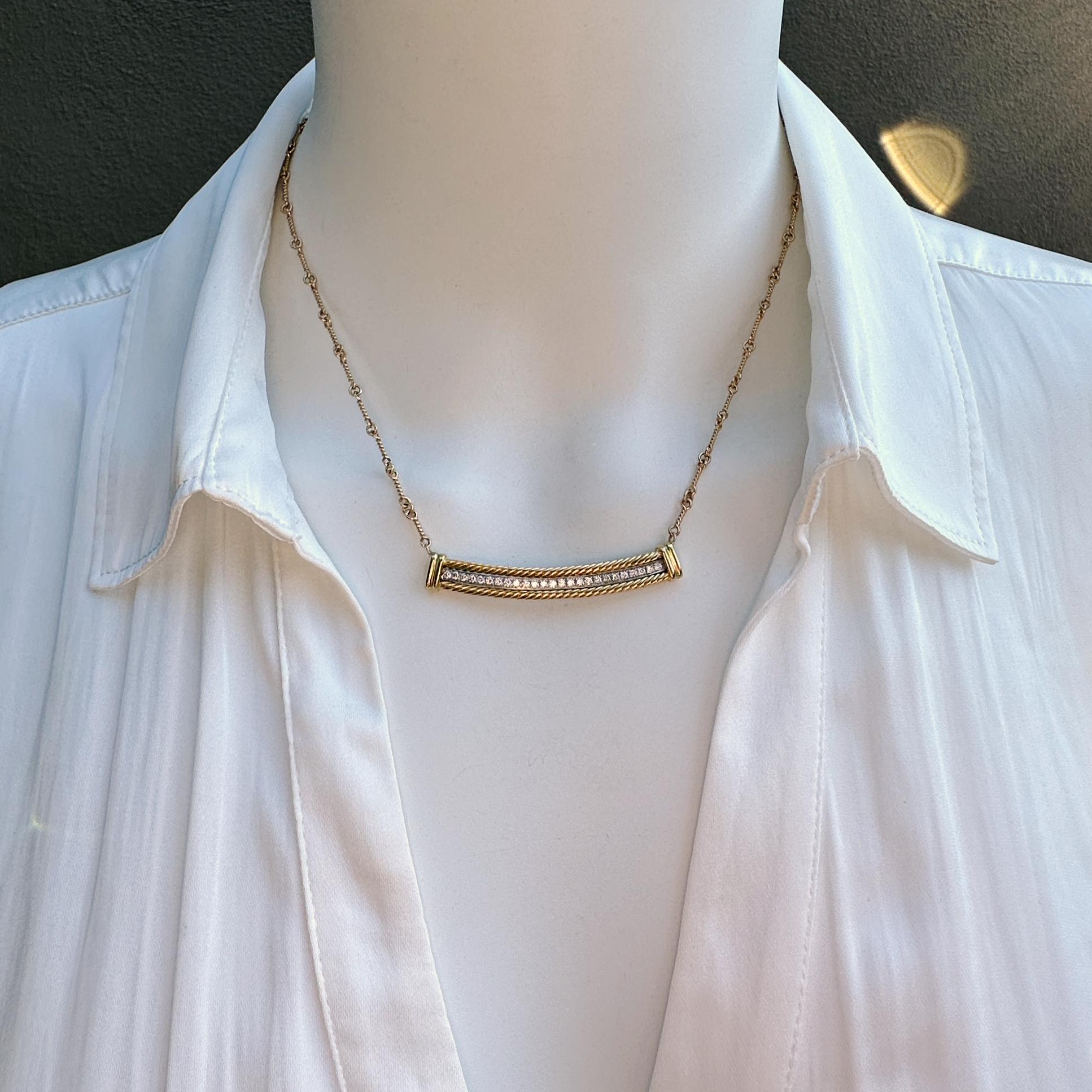 A cut above your standard diamond bar necklace, this one features a slightly curved line of bright white diamonds set on white gold between 18 karat yellow gold cables.  Tidy caps at the ends mark the transition to the cool bar chain with twisty