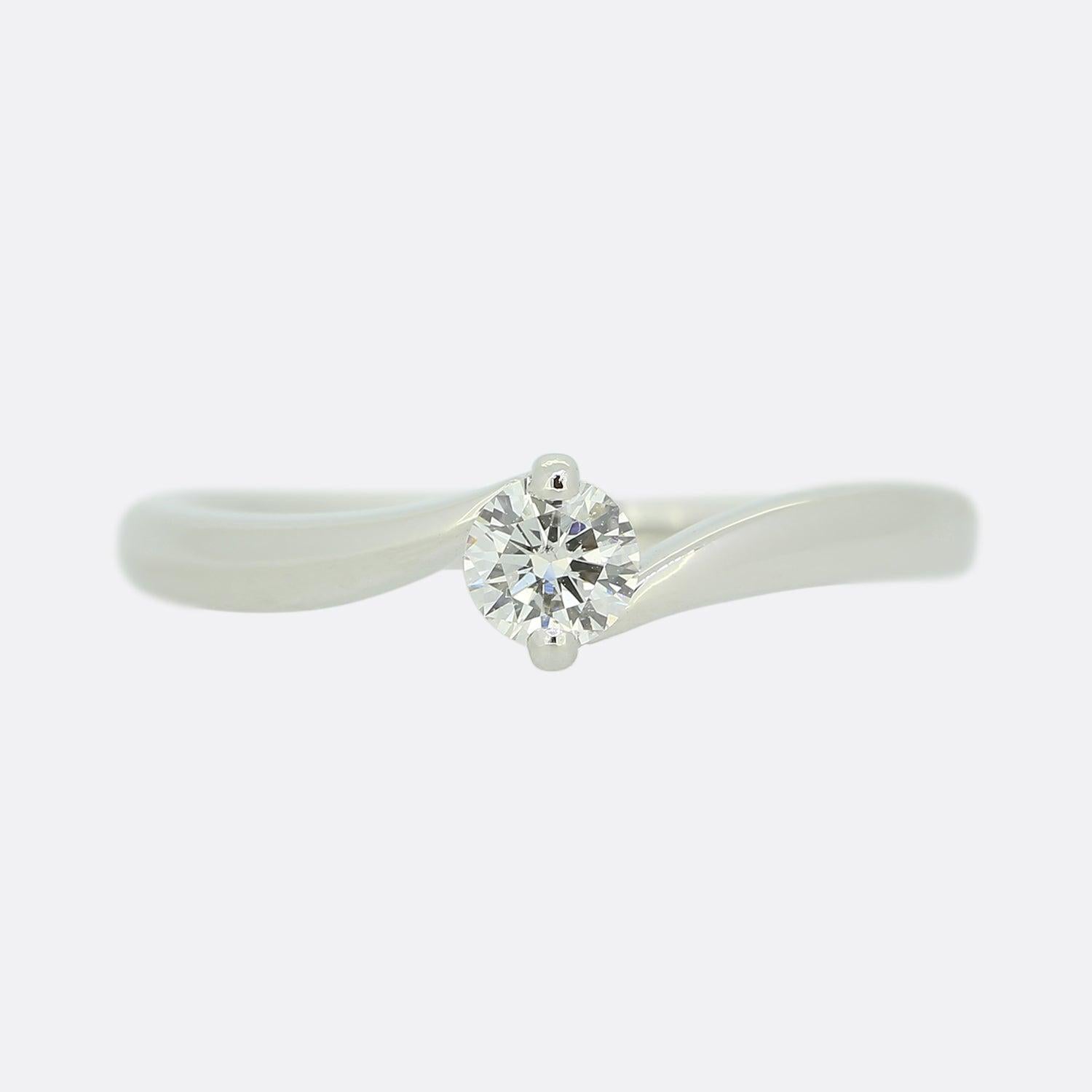This is a platinum diamond crossover ring. The ring is set with a single brilliant round cut diamond in a 2 pronged mount.

Condition: Used (Very Good)
Weight: 4.8 grams
Size: O
Total Diamond Carat Weight: Approx. 0.25 carats
Diamond Details: