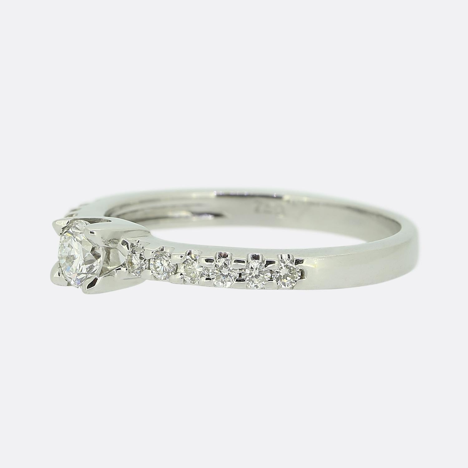 Here we have an 18ct white gold diamond engagement ring. The central round brilliant cut diamond weighs 0.25 carats and has been claw set amidst a pair of shoulders playing host to an additional six round brilliant cut diamonds.

Condition: Used