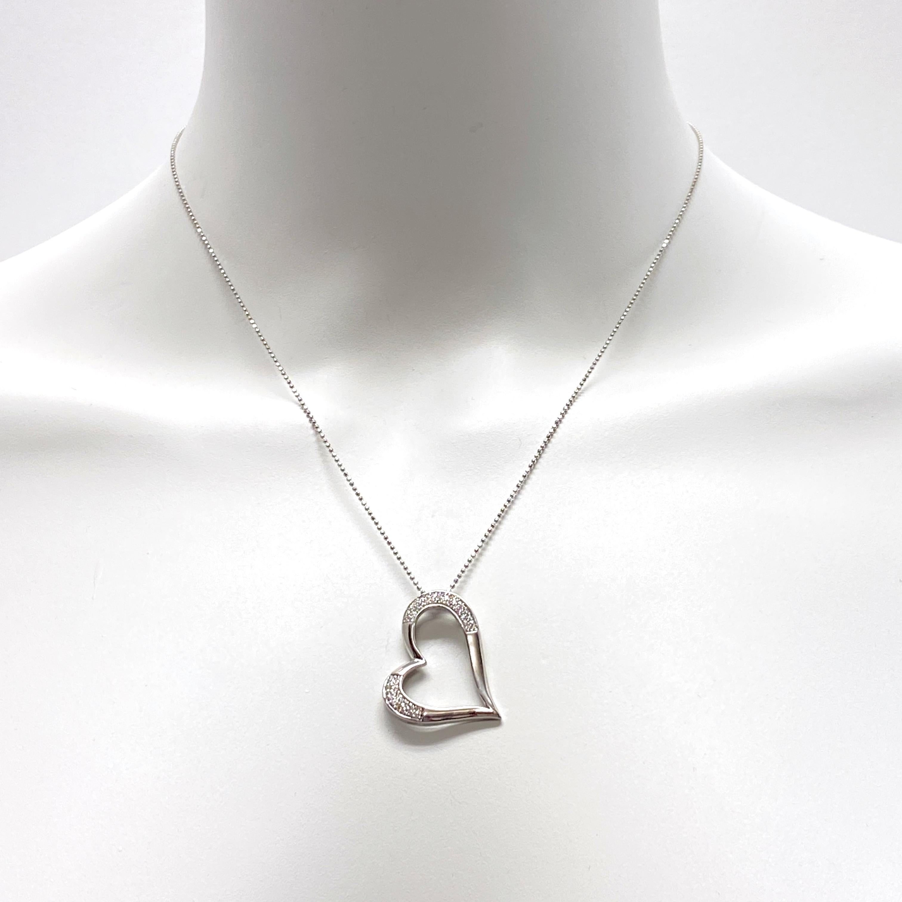 Eytan Brandes' sexy, sleek sideways heart pendant in high-polish 14 karat white gold features two panels of extremely small, neatly set natural white (untreated, earth-mined) diamonds -- a total of fifty stones for a total diamond weight of a