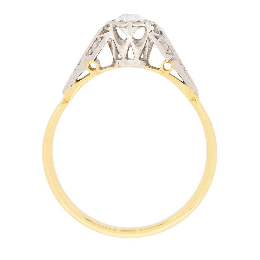 An old cut diamond weighing 0.25 carat is claw set within an illusion style mounting and presented between hand-engraved platinum shoulders at the centre of this vintage 1920s diamond solitaire engagement ring. The balance of the ring's original Art