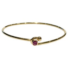 0.25 Carat Pink Sapphire Bezel Set in 18 Carat Yellow Gold Wire Bangle