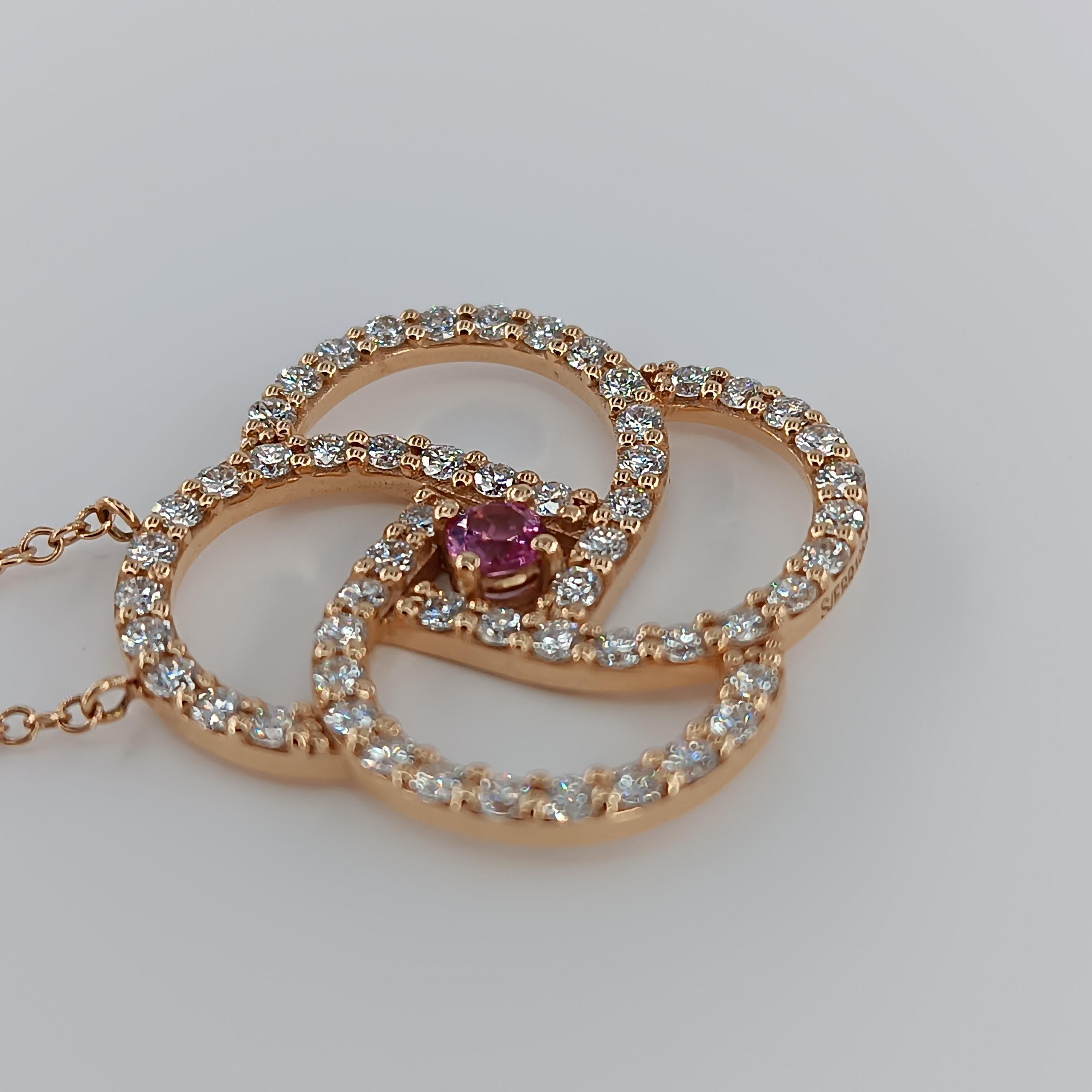 This beautiful pendant made of 18 carat Rose gold for 9.92 grams boasts a central  pink Sapphire  of 0.25 carat and 56 VS G color diamonds for a total of 1.68 carats. 
any item of our jewelry collection has a dedicated identification number lasered