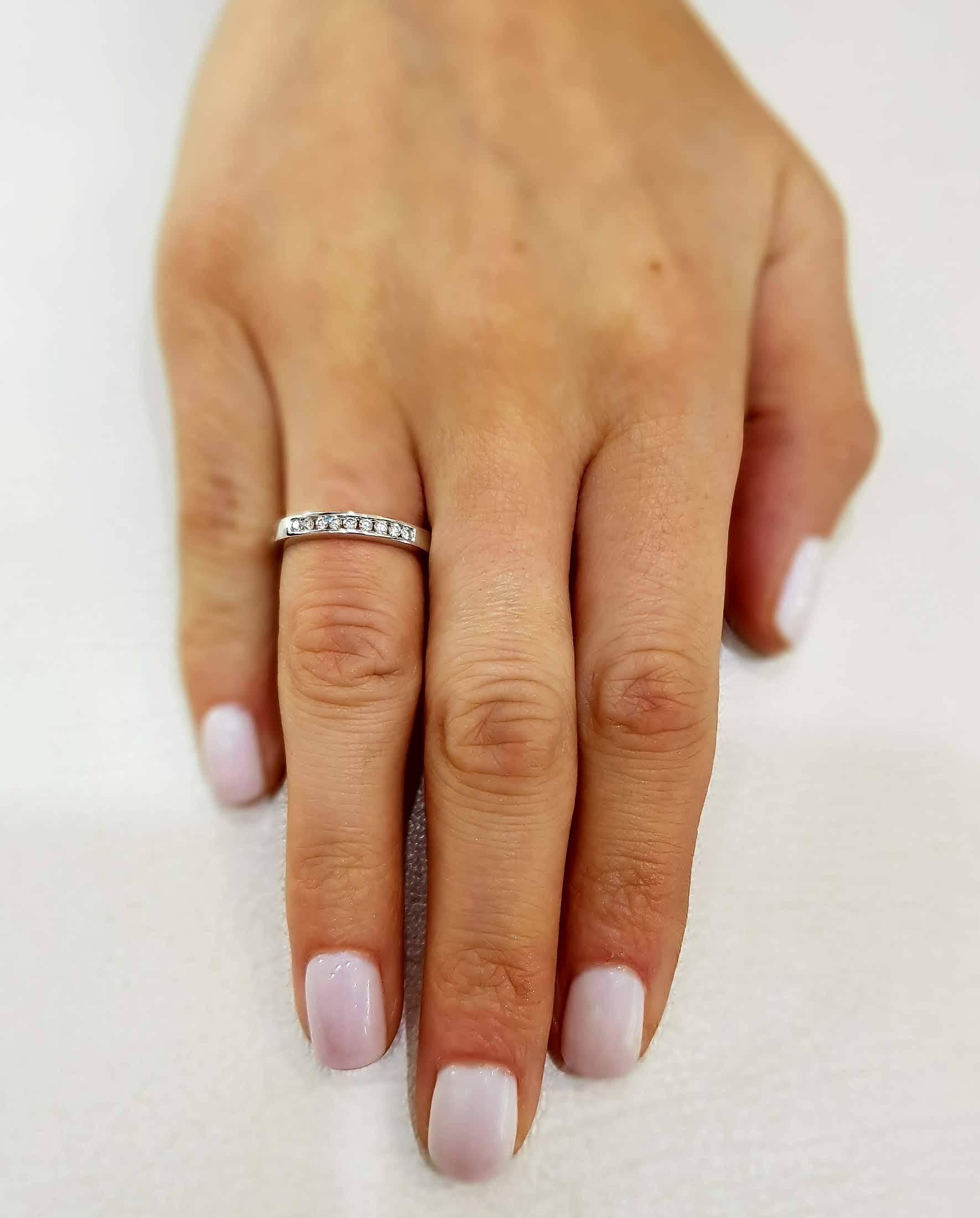 This channel set 18ct White Gold half Eternity ring is an exquisite addition to our collection. A sparkling array of nine H-SI1 Round Brilliant Diamonds for a classic and iconic look. This ring has a total diamond weight of 0.25 Carats. The weight