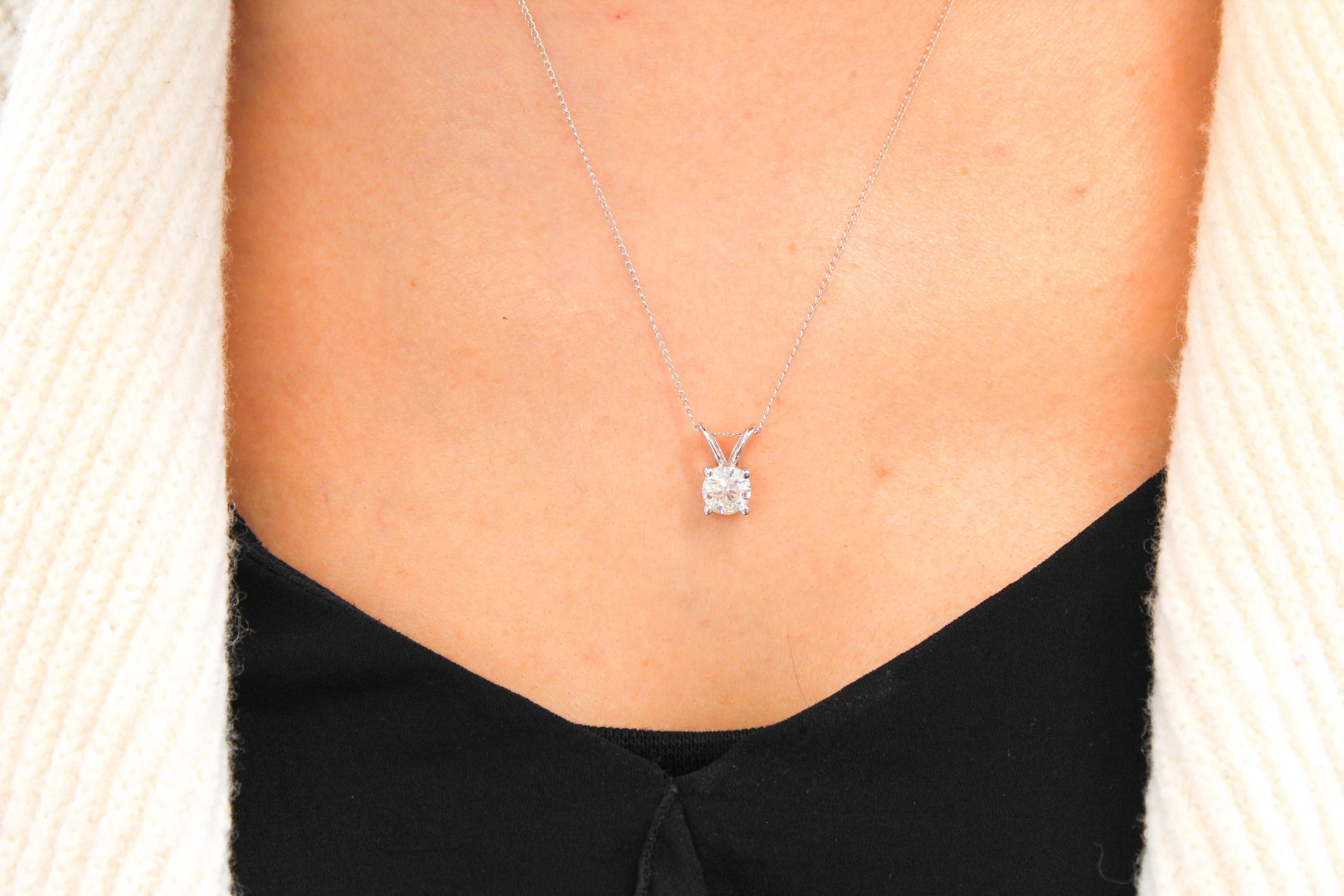 This impressive diamond solitaire pendant is finely crafted in brightly polished 14 karat rose gold and features a round shaped 0.25 carat diamond that has SI clarity, gracefully prong set on a shiny split bail. Ideal as an anniversary or birthday