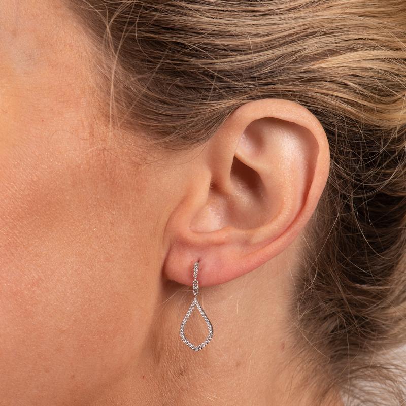 These dangle earrings feature 0.25 carat total weight in round diamonds set in 14 karat white gold. Friction post and back. 
Measurements: Length approximately 25mm
