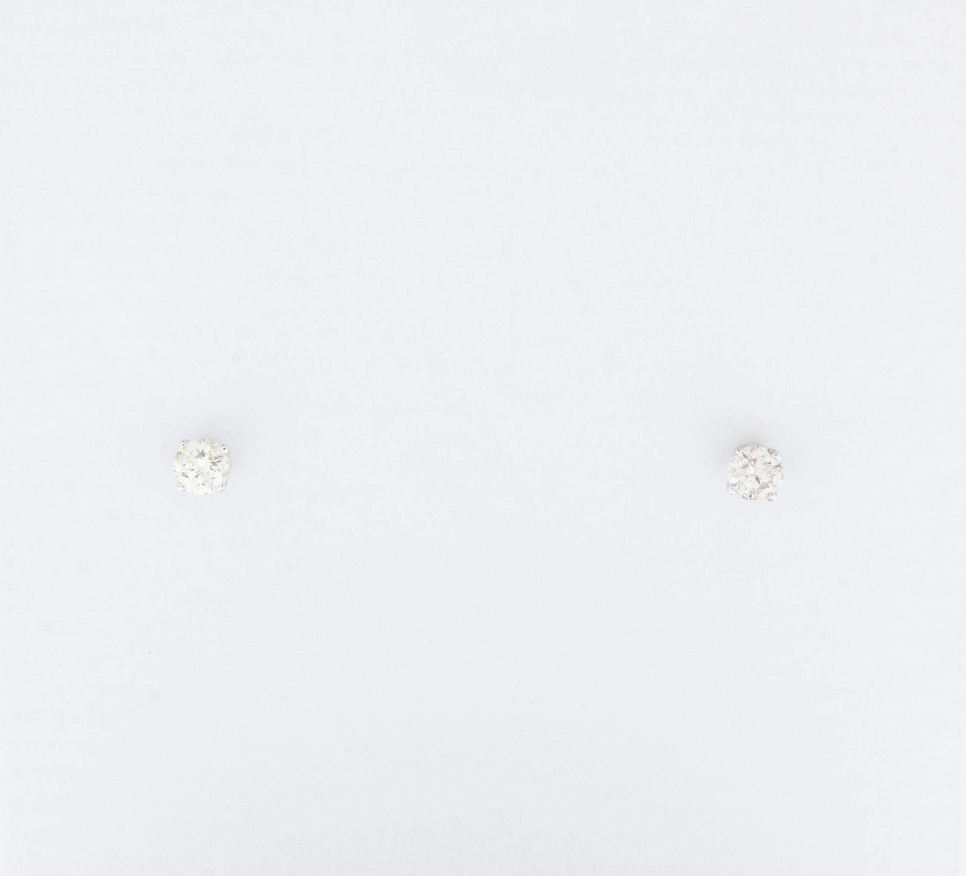 Stunning 14 Karat white gold handmade earrings featuring 2 round brilliant cut diamonds weighing 0.25 carat total I-J color and I1 clarity. These gorgeous earrings are classic and timelessly elegant.