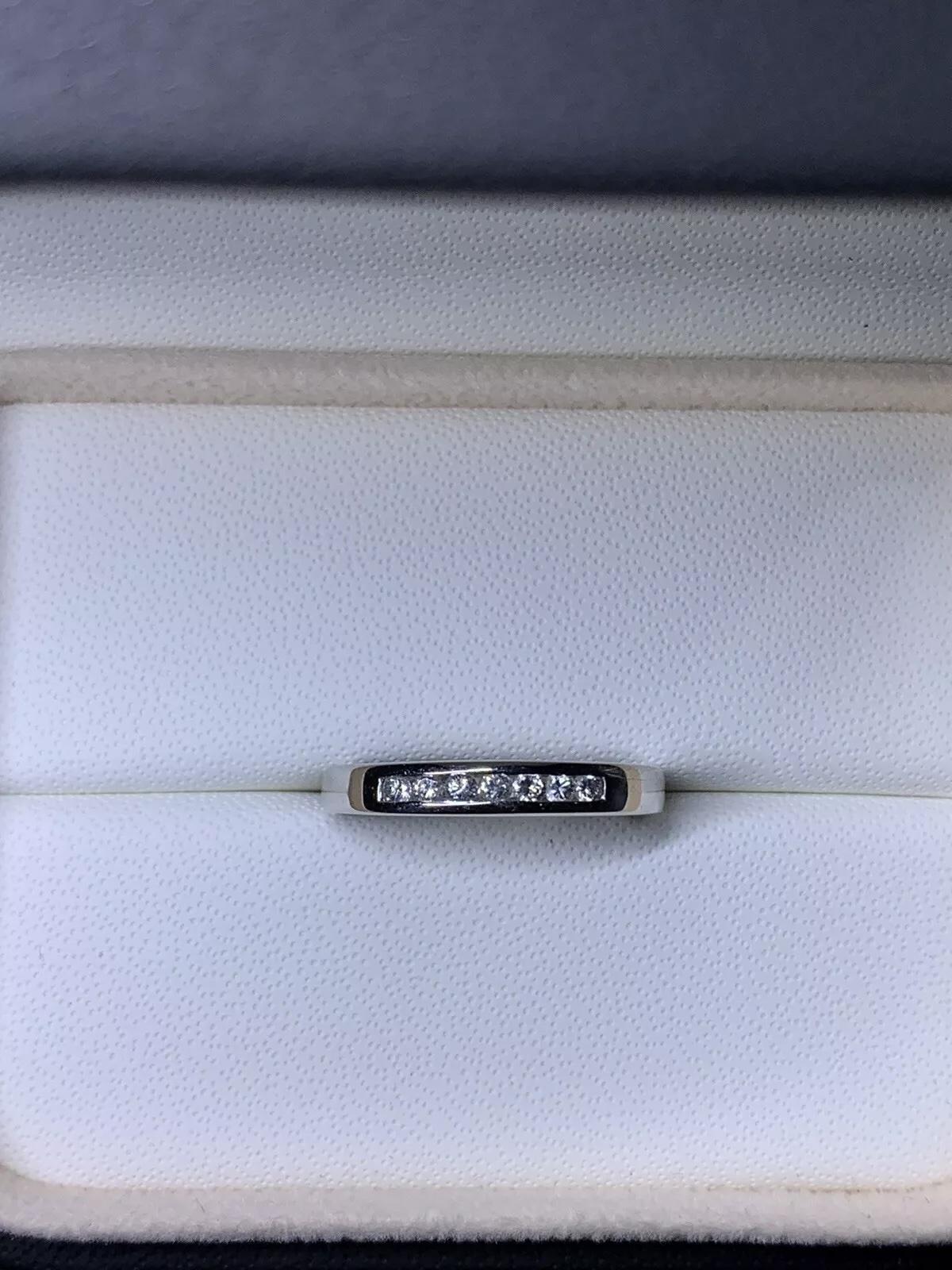 This beautiful handcrafted wedding band features a stunning 0.25ct diamond set in 18ct white gold. The ring is chunky and perfect for those who love unique, unisex designs. The diamond is channel-set and has a very slight inclusion (VS1) clarity