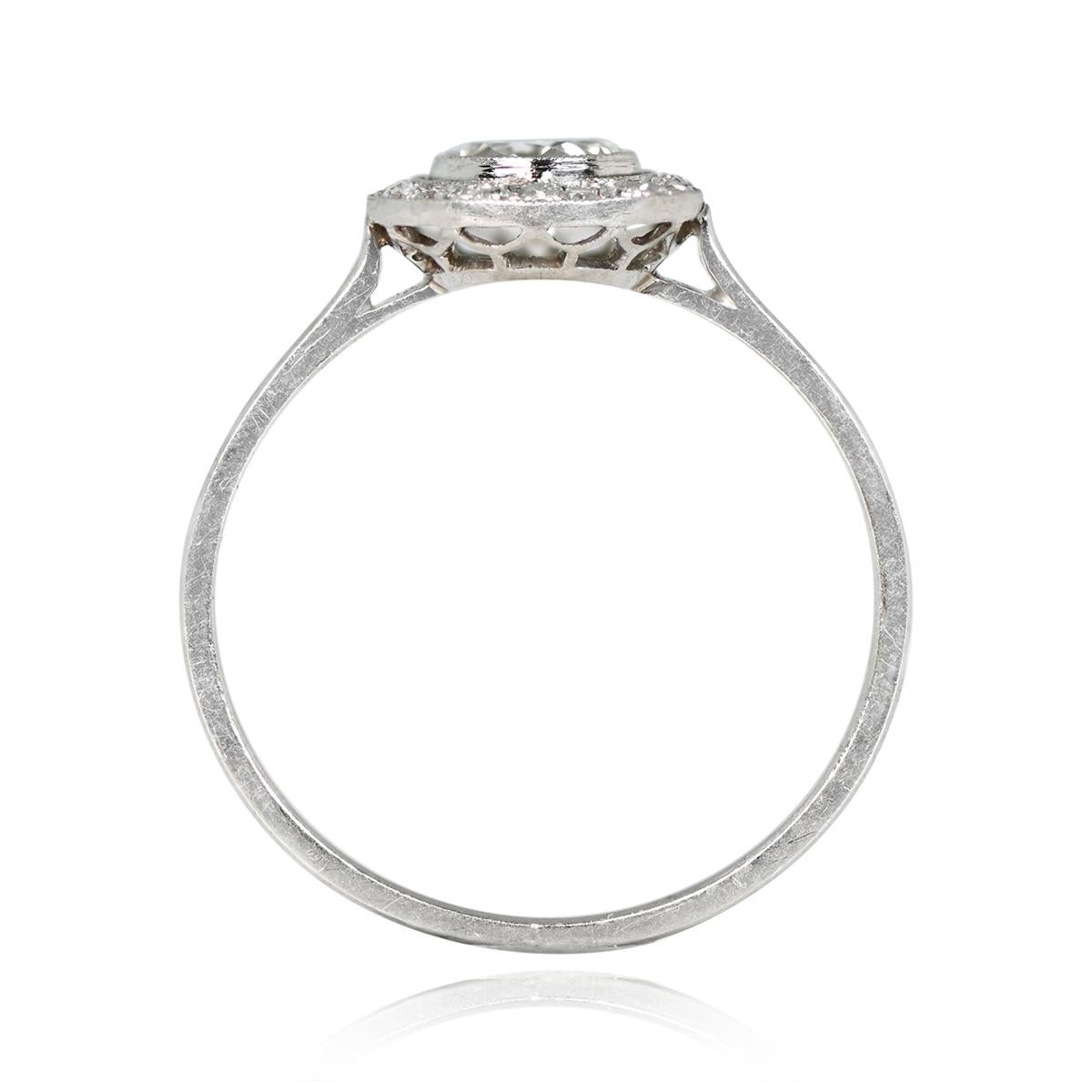 An engagement ring showcasing an elegant round cut diamond, expertly bezel-set, and accompanied by a stunning halo of single-cut diamonds. The center diamond boasts a weight of 0.25 carats, emanating a radiant sparkle. Its L color and I2 clarity