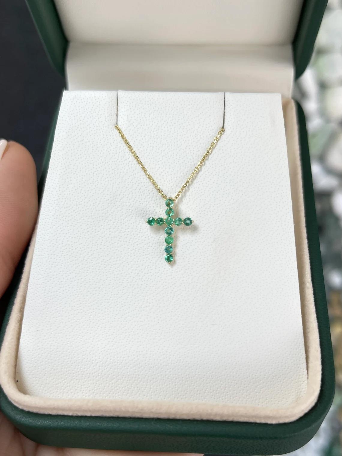 A token of faith, a symbolic emerald cross. This petite pendant features numerous bluish-green emeralds, prong-set in a simple yet beautiful gold prong setting. Crafted in 14K gold, and ideal for everyday wear and stacking.

*Chain sold separately.