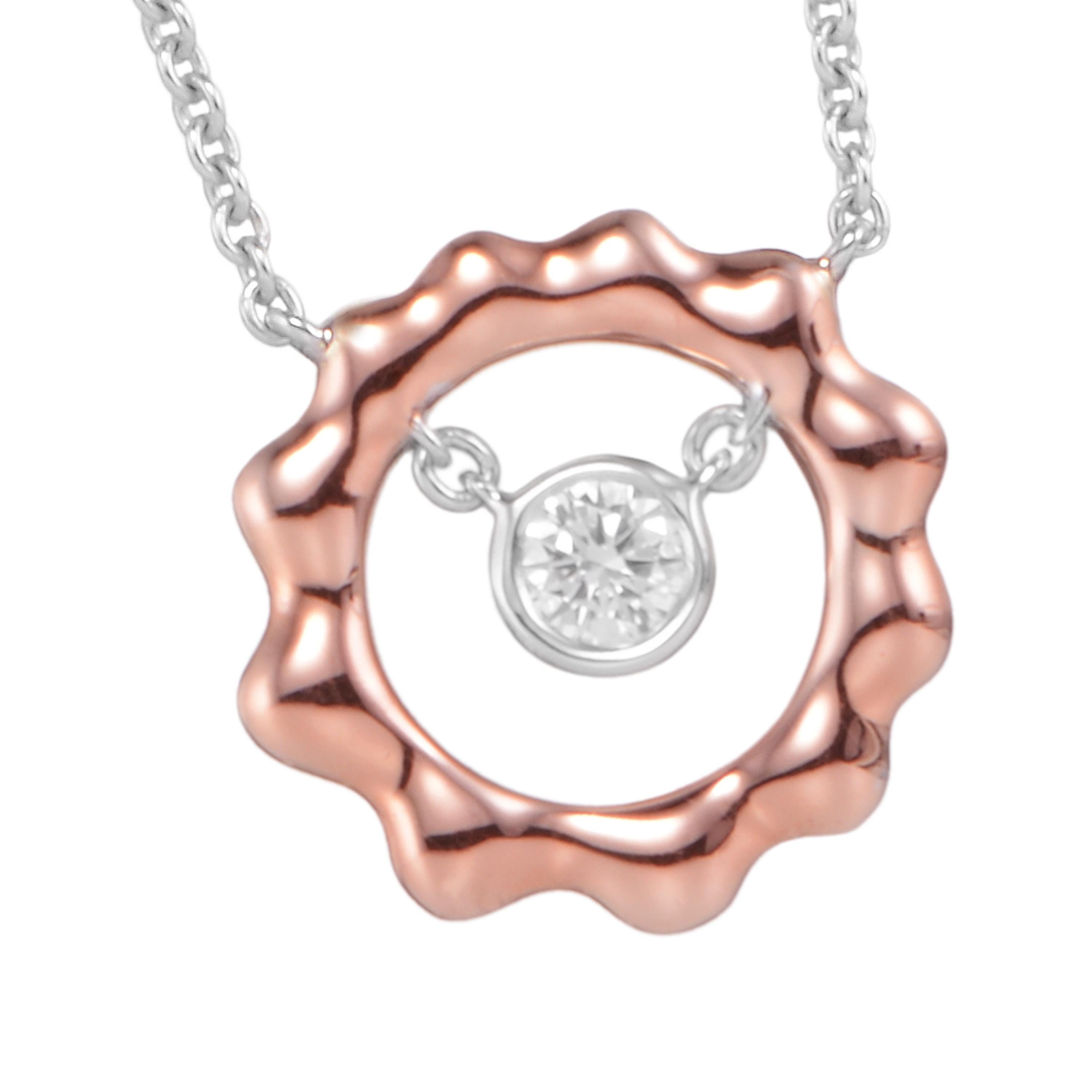 Cast in the shape of the sun, Butani's pendant necklace is handcrafted from 18-karat rose and white gold and has a 0.26 carat brilliant-cut round diamond center illuminated by a rose gold sun silhouette.  Wear it solo or layered with other pieces. 