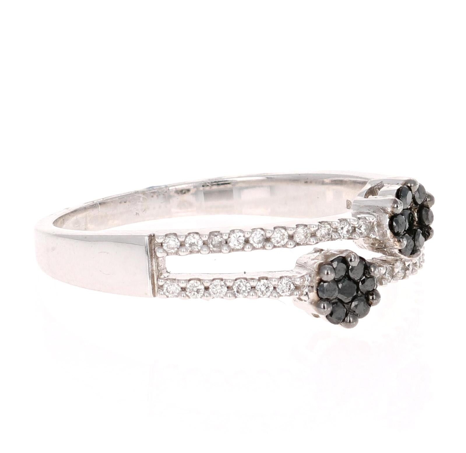A simple everyday black and white flower ring! This classic design is going to compliment almost anything in your wardrobe and can be a cute add on to other rings on your hand! 
There are a total of 46 Round Cut Black and White Diamonds that weigh