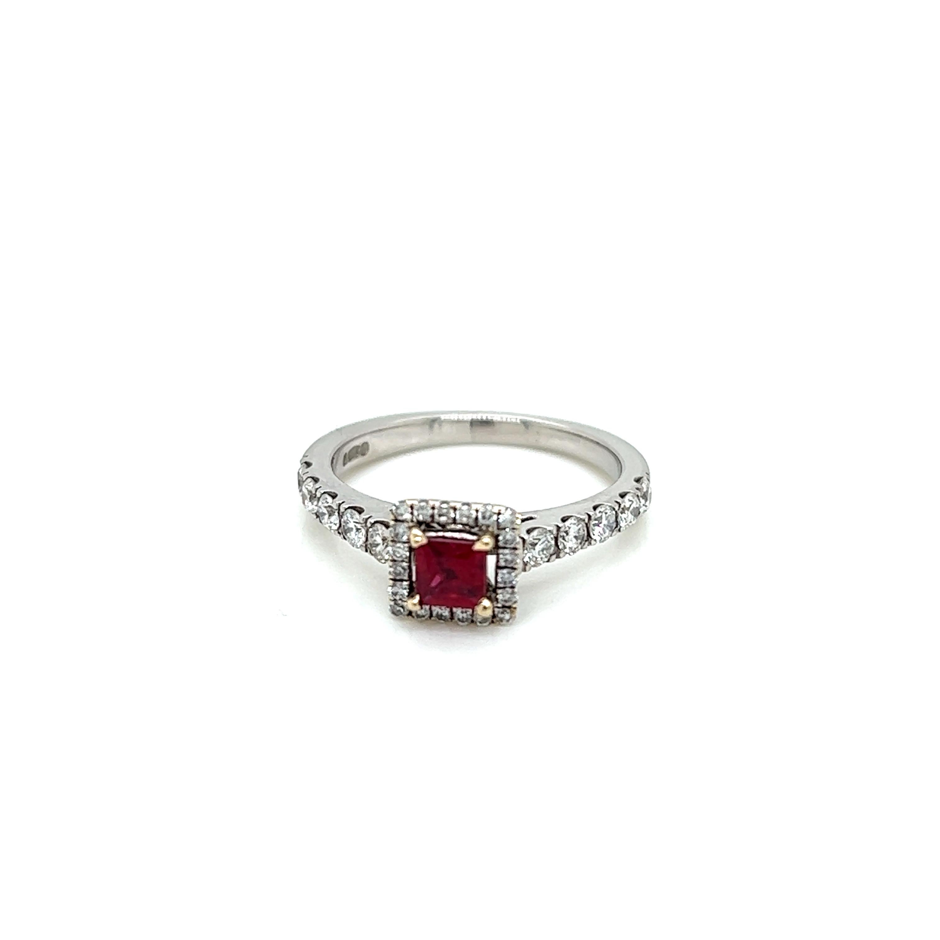 This ring features a spectacular 0.27 carat princess cut Ruby at its centre, surrounded by a frame of round brilliant Diamonds set on a Platinum band with round brilliant shoulder Diamonds.

The Ruby at the centre of this ring is a marvellous deep,