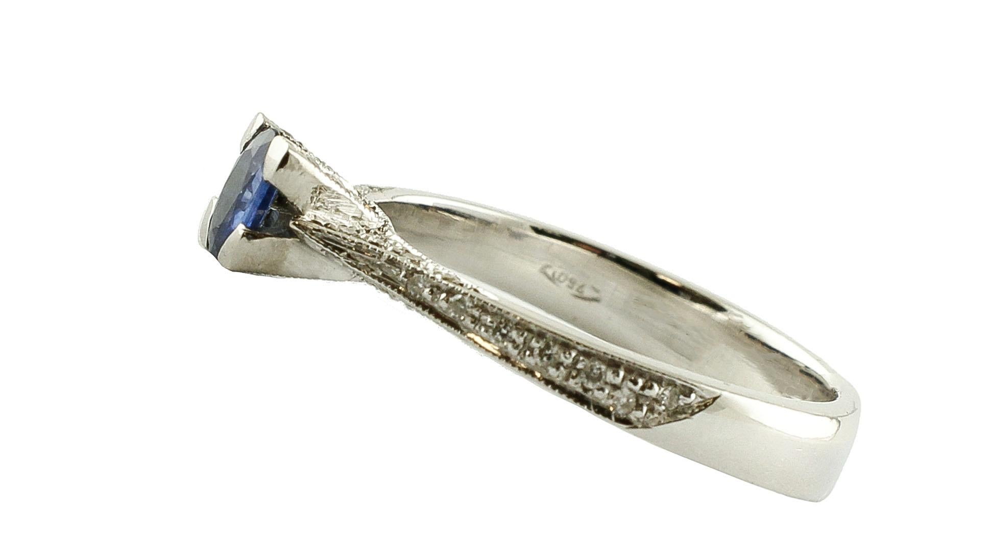 Simple and classic solitaire/engagement ring in 18k White gold mounted with an amazing 0.27 ct of blue sapphire in the center, and adorned with 0.23 ct of little white diamonds on the two sides.
Diamonds 0.23 ct 
Blue Sapphire 0.27 ct    /    5 mm X