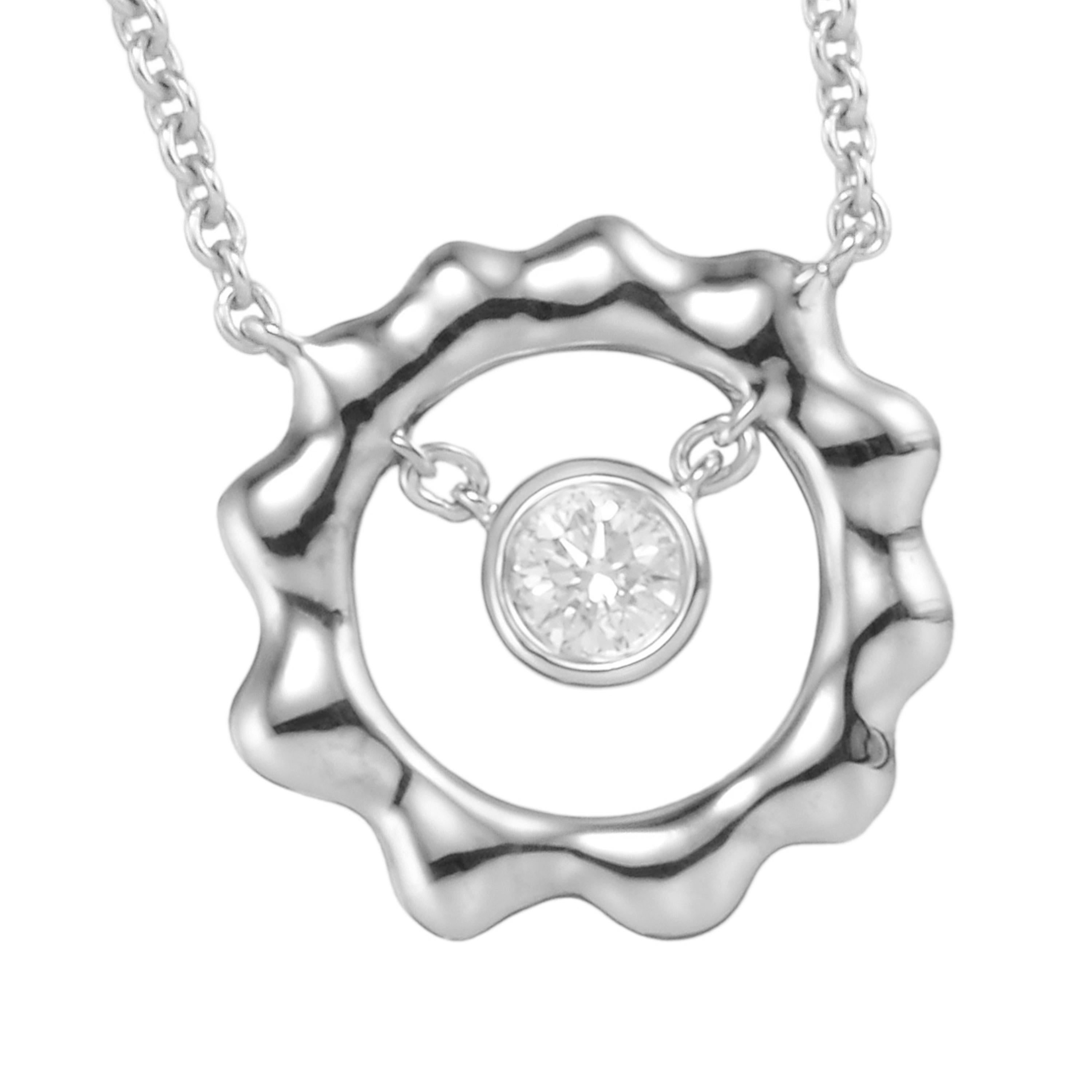 Cast in the shape of the sun, Butani's pendant necklace is handcrafted from 18-karat white gold and has a 0.28 carat brilliant-cut round diamond center illuminated by a white gold sun silhouette.  Wear it solo or layered with other pieces.  Chain