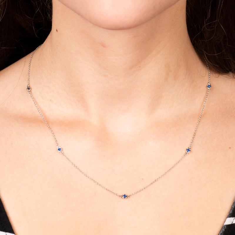 This station necklace is part of the Soft Glamour collection, featuring 0.29ctw in 5 round blue natural sapphires that are bezel set in 14kt white gold and an 18 inch chain. This dainty necklace is the perfect way to subtly implement colored stones