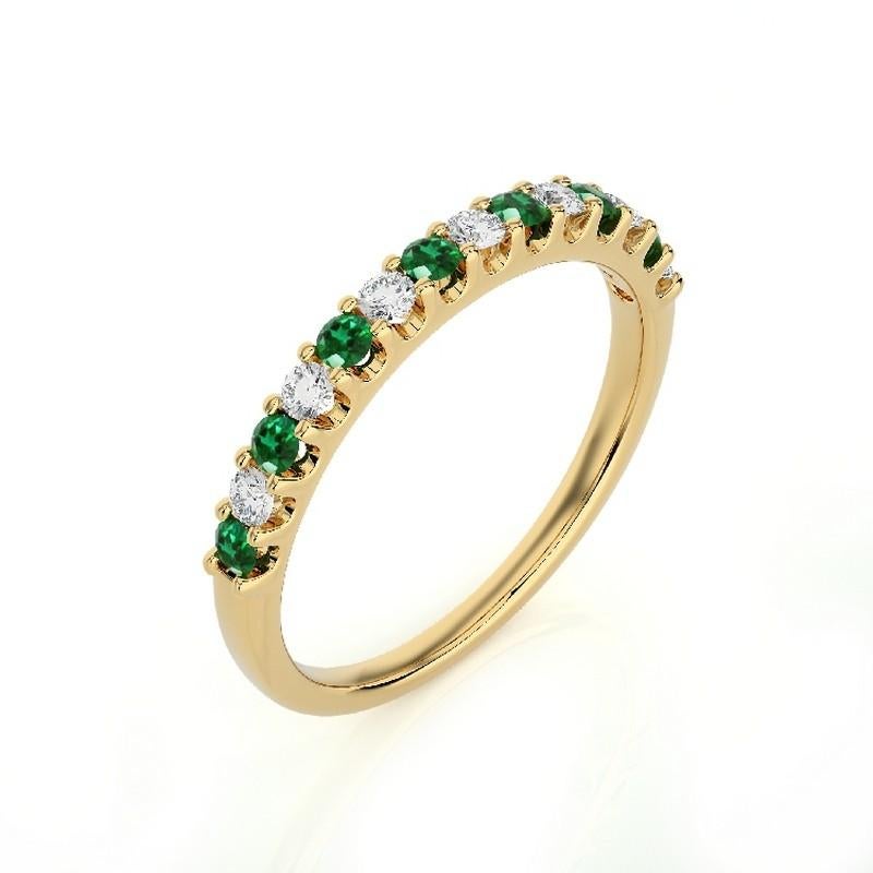 Diamonds and Emeralds: Seven meticulously selected round diamonds and seven round emeralds grace this wedding ring, each securely set in a classic prong setting. The total carat weight of 0.2 carats ensures a captivating and enduring sparkle, and