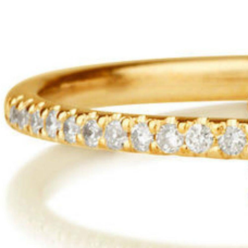 A handmade solitaire with accents Ruby engagement ring made of 14K Yellow Gold set with a Round cut Ruby of 0.30 carat accented by 12 natural round diamonds. The center stone of this unique engagement ring is of excellent cut and Red color, 0.3