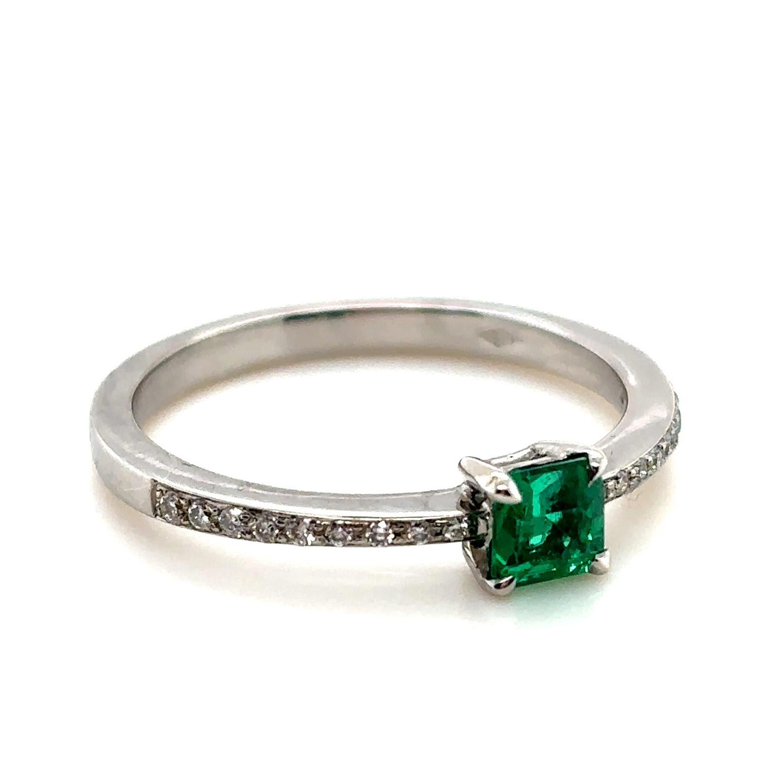 A 0.30 carat Columbian emerald and diamond 18 karat white gold ring.

This beautiful emerald and diamond engagement ring is crafted in 18 karat white gold. Claw set to its centre with an emerald cut emerald of 0.30 carats. This striking stone is a