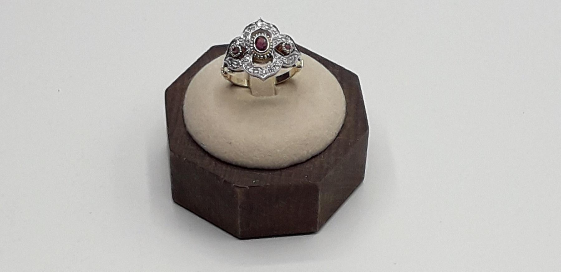 yellow and white gold ring with 0.30 carat brillant cut diamonds and 0.40 carat rubys. New contemporary jewelry.  Ring size Italian 15 please see the conversion in the picture. This beautiful ring of Italian luxury jewelry is perfect for a refined