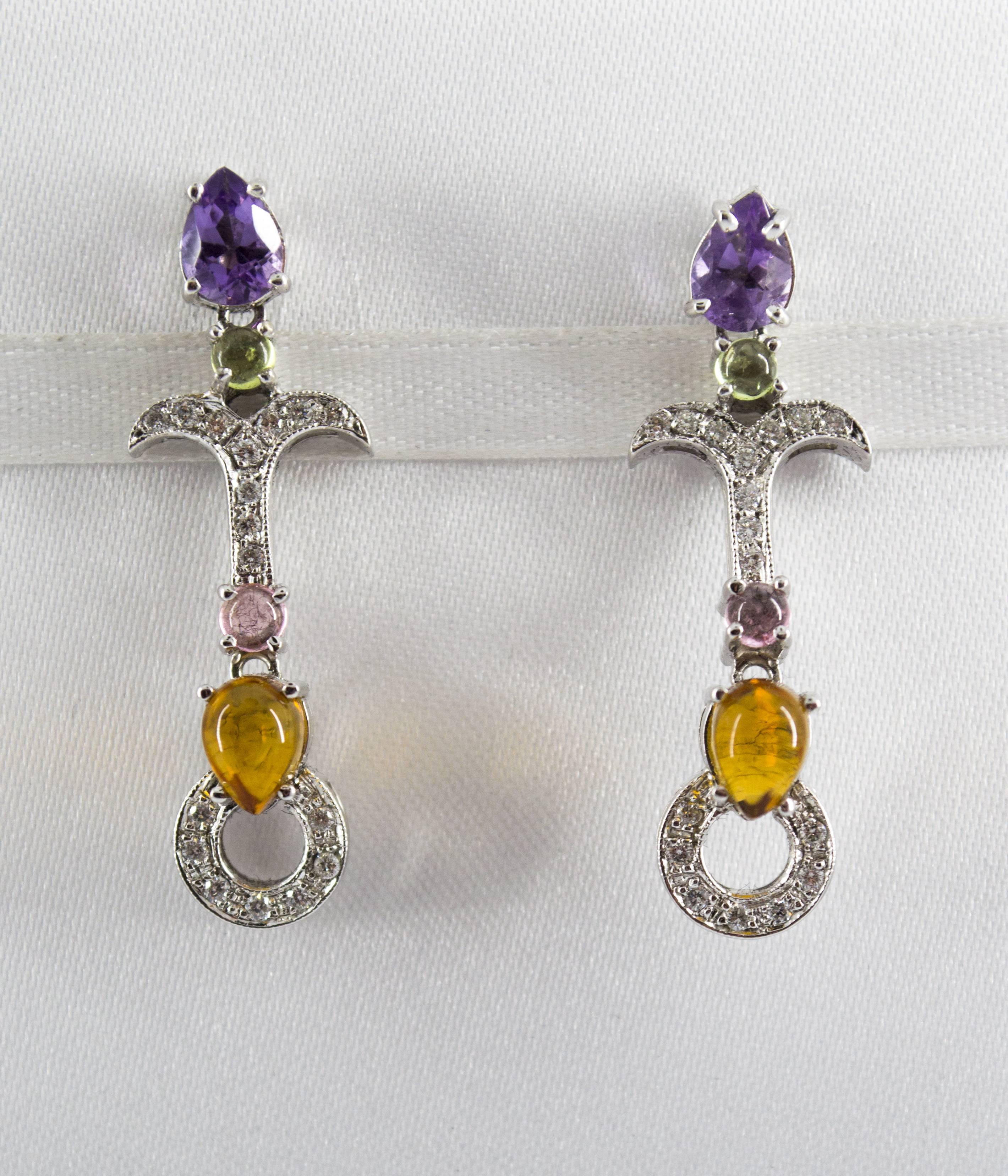 These Earrings are made of 9K White Gold.
These Earrings have 0.30 Carats of White Diamonds.
These Earrings have also Amethyst and Citrine.
All our Earrings have pins for pierced ears but we can change the closure and make any of our Earrings