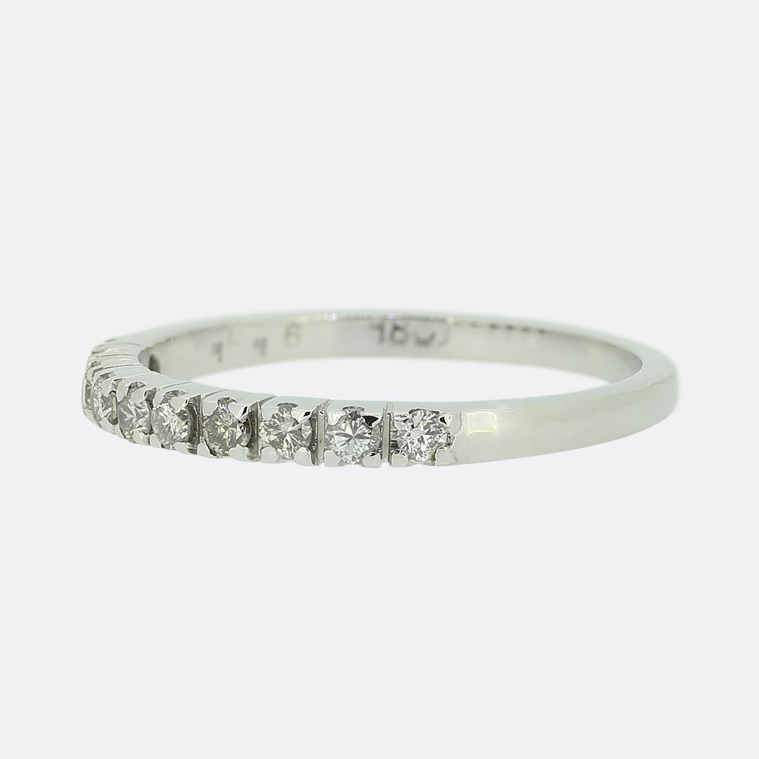 Here we have an 18ct white gold diamond half eternity ring. The ring features ten round brilliant cut diamonds; all of which have been individually claw set in a collective single line formation whilst the remainder of the band possesses a plain