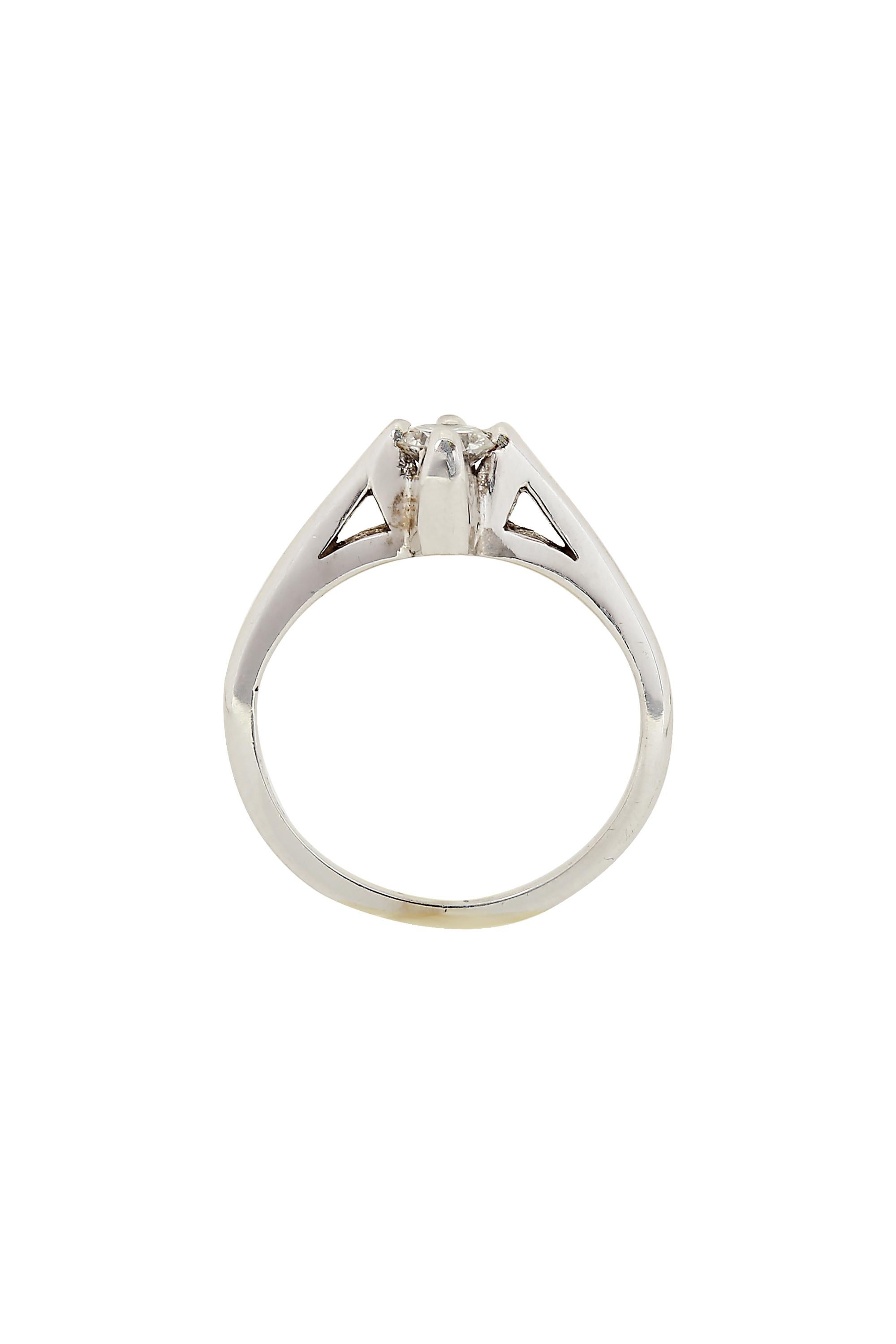An updated take on the classic solitaire setting, this ring features a boldly set white round brilliant diamond of approximately .30 carats, G VVS2 in color and clarity. Crafted in 14 karat white gold and currently a size 4.5. May be resized. Circa