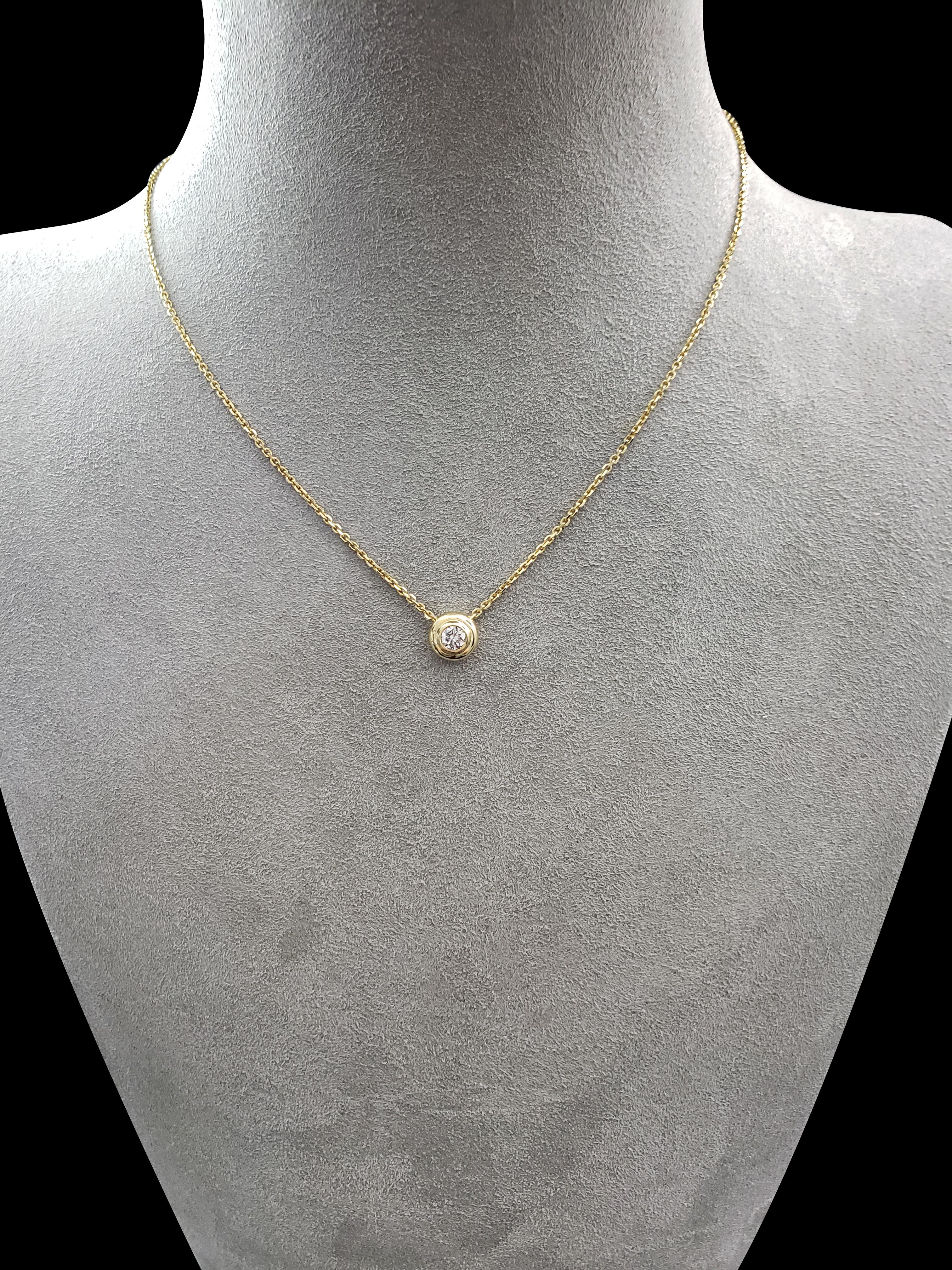 A single round brilliant diamond weighing 0.30 carats is showcased in this 14 karat yellow gold pendant necklace. The diamond is fashioned in a polished yellow gold bezel. Comes with a 18 inch yellow gold chain.

Style available in different price