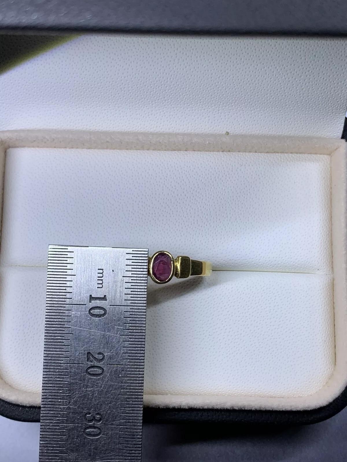 Pink ruby gemstone oval shaped bezel set antique style engagement ring in 18ct yellow gold

Ruby oval shaped total weight 0.30ct natural untreated.

Hallmarked

The ring can be resized

Box not included.

Comes with bag.

Valuation included.

This