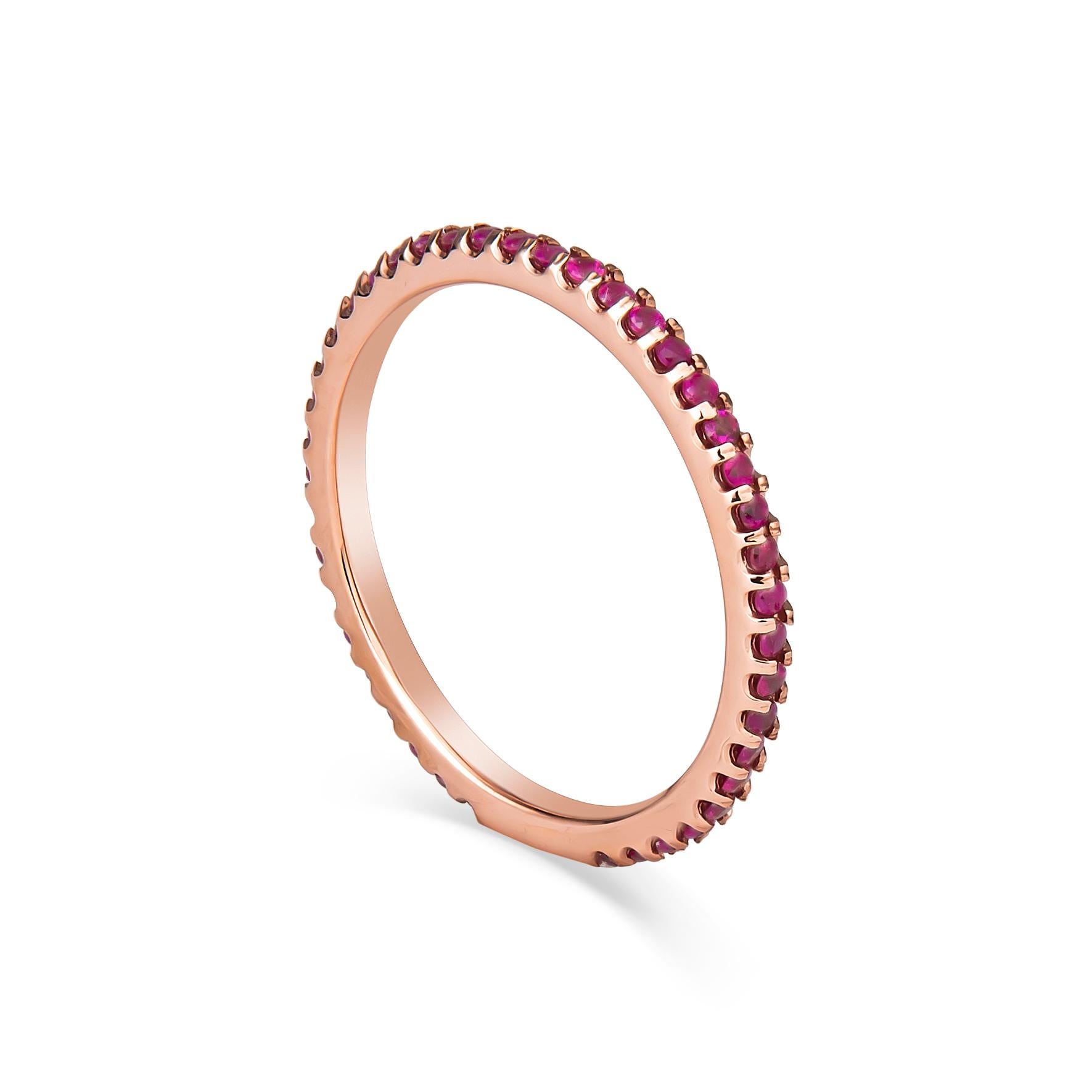 This stacking band is comprised of 0.30ct total weight in 42 round dark pink/magenta natural sapphires set with split-prongs. The band is 14kt rose gold, approximately 1.7mm wide and a size 6. The ring has some sizing space and can be resized upon