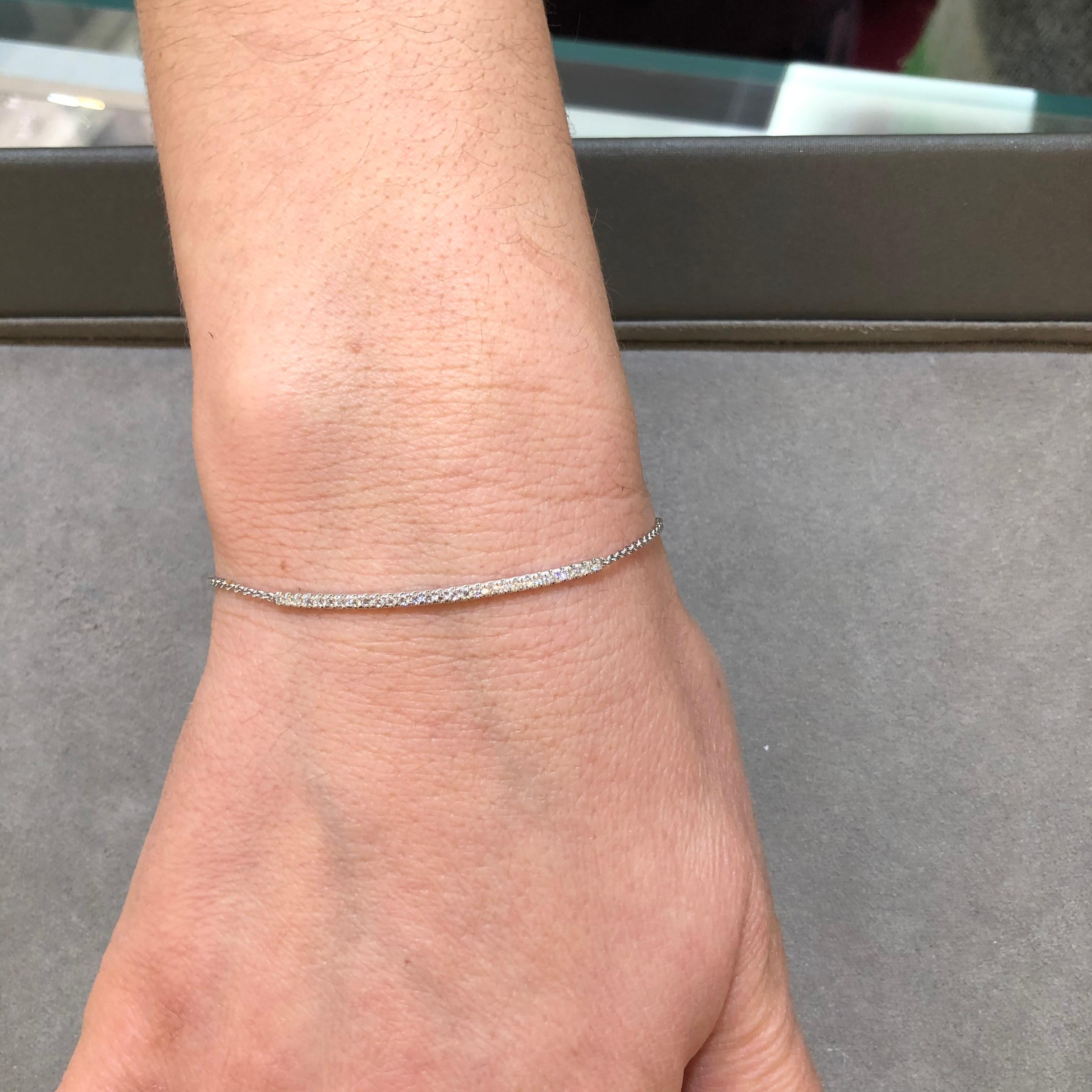 A simple bracelet showcasing a row of brilliant round diamonds weighing 0.31 carats, set in a curved line. Made with 14K White Gold, attached to white gold chain. 

Style available in different price ranges. Prices are based on your selection.