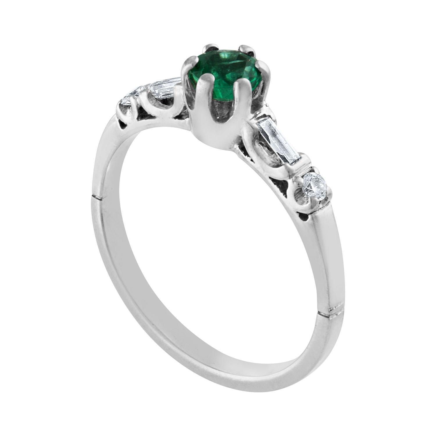 The ring is Platinum
The Emerald is a round 0.31 Carat Natural Emerald
There are 0.10 Carats in Diamonds F/G VS
There are 2 round diamonds and 2 baguette diamonds
The ring is a size 6.0, sizable.
The ring weighs 3.3 grams