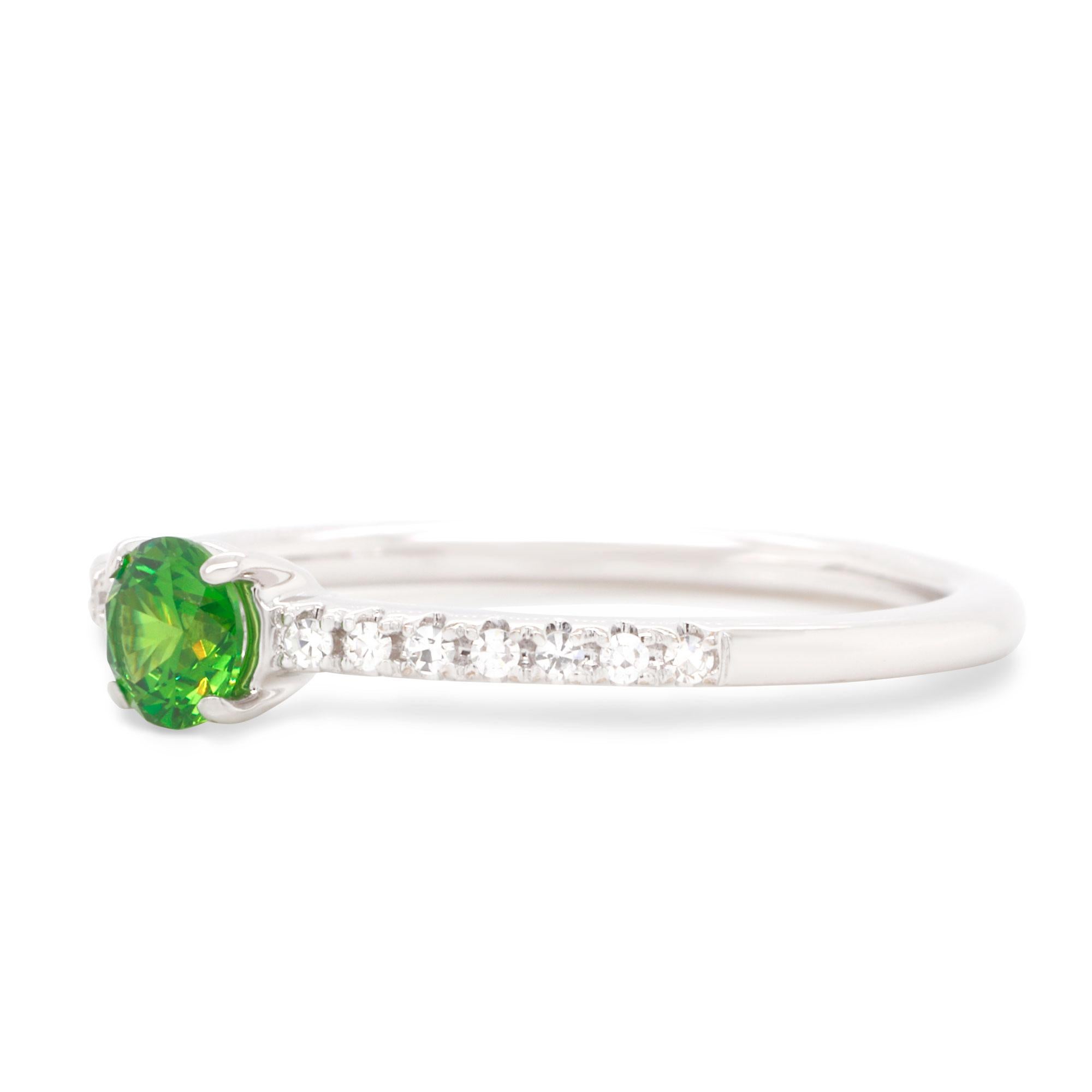 Wonderful 14K White Gold Ring. Center stone is a unique Russian Demantoid 0.31 ct, accented by white Diamonds 0.064 ctw. Simple but yet elegant design makes this ring perfect for any occasion. You can wear it everyday to emphasize your style, it can