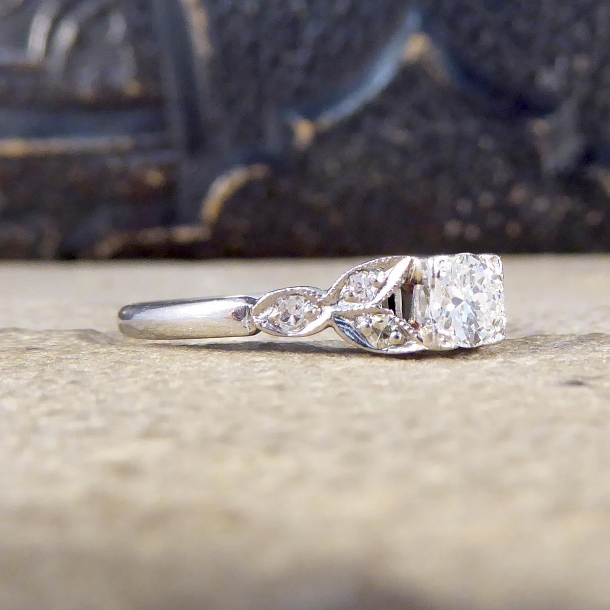 This ring was hand crafted in the Edwardian era and modelled form platinum. In the centre sits a 0.25ct Round Cut Diamond with leaf shaped shoulders with three small Diamonds on each shoulder making a total of 0.31ct. A classic Edwardian ring that
