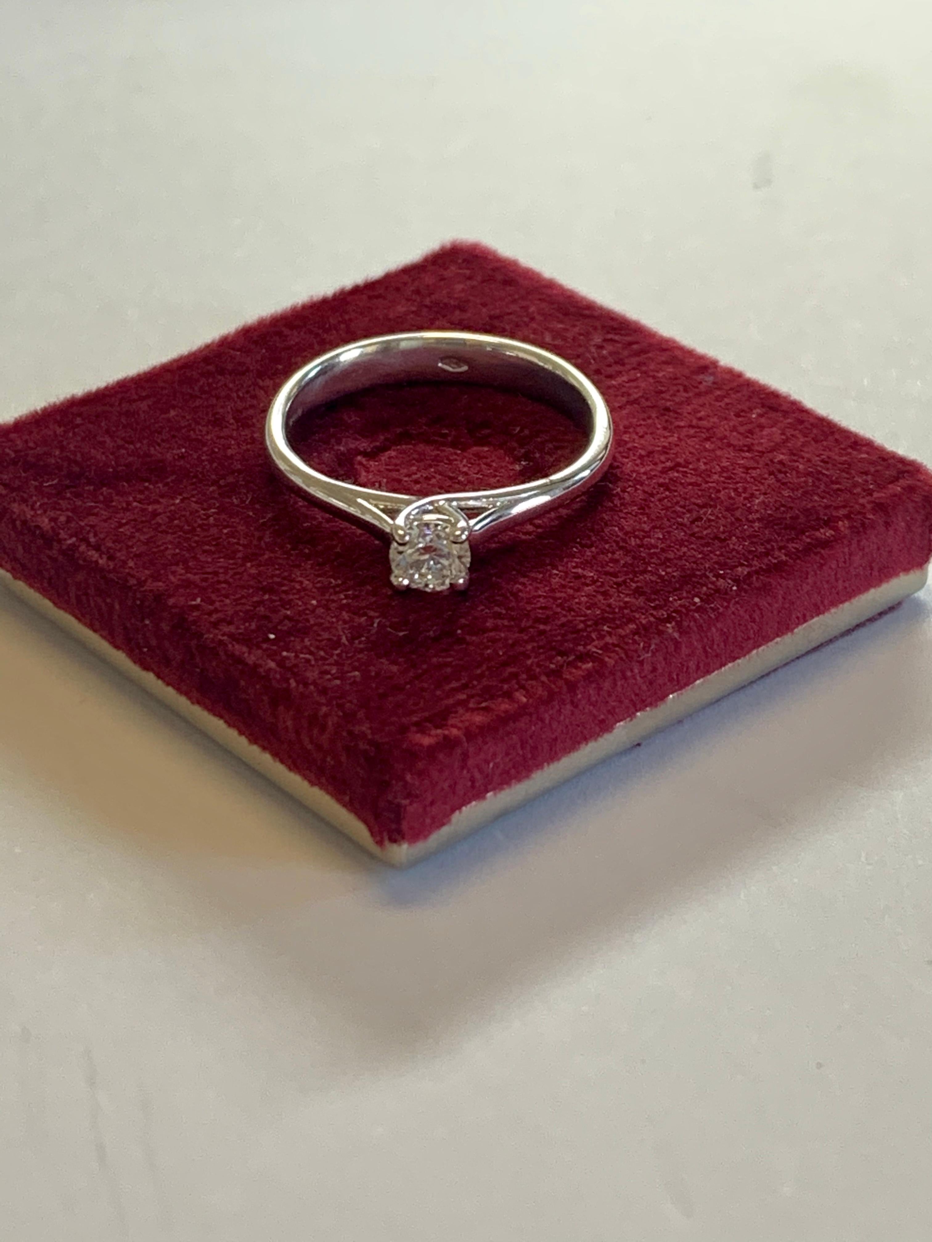 This 0.32 carat solitaire has a slight raised twist in the prongs that elevates the Diamond enabling more light to reflect off it. 

Set in 18Kt white gold, and a beautiful ring to wear every day or for special occasions based on your