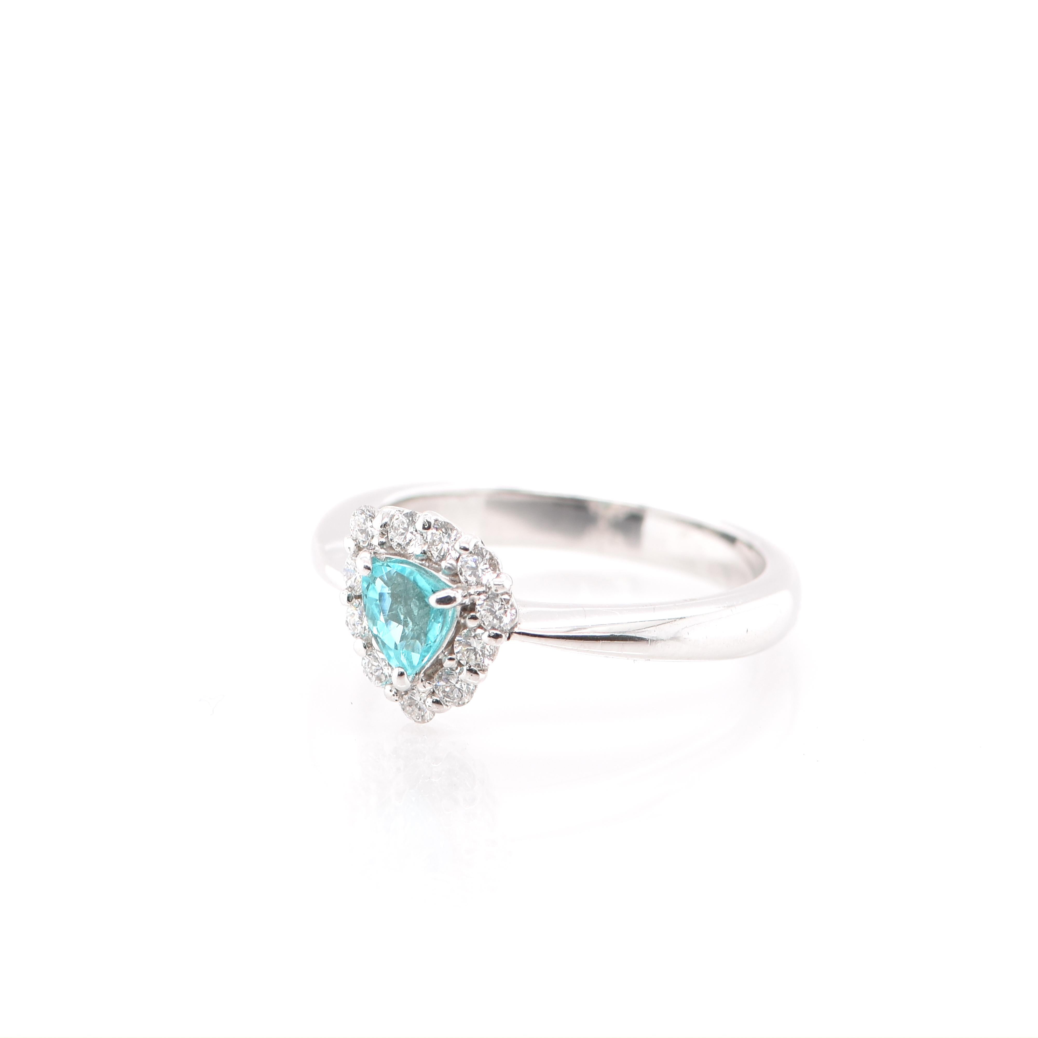 A beautiful and elegant ring featuring a GIA Certified 0.32 Carat Trillion Cut Paraiba Tourmaline and 0.25 Carats of Diamond Accents set in Platinum. Paraiba Tourmalines were only discovered 30 years ago in the Brazilian state of the same name-