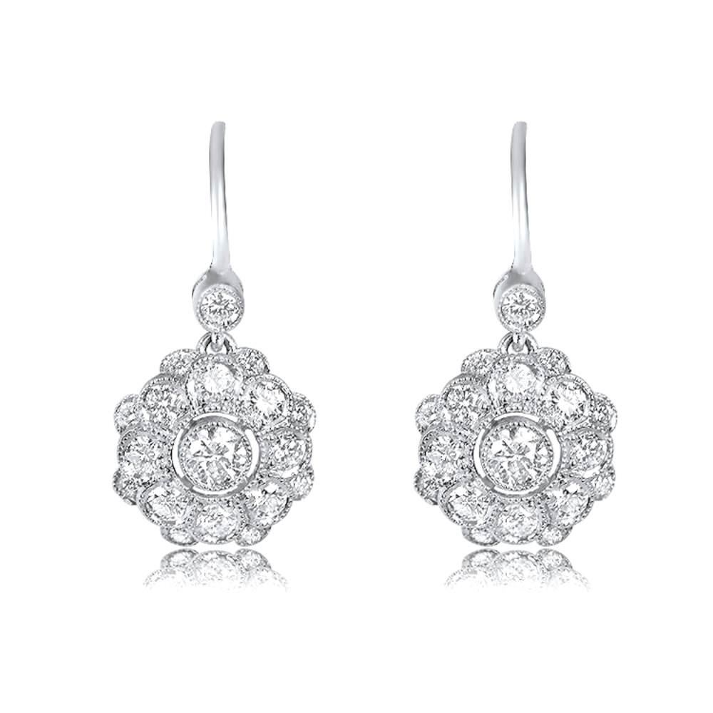 Adorn yourself with the enchanting beauty of these floral cluster earrings. Gracing the center are two mesmerizing diamonds, weighing around 0.32 carats, while a radiant cluster of diamonds surrounds them. The diamond accents further enhance the