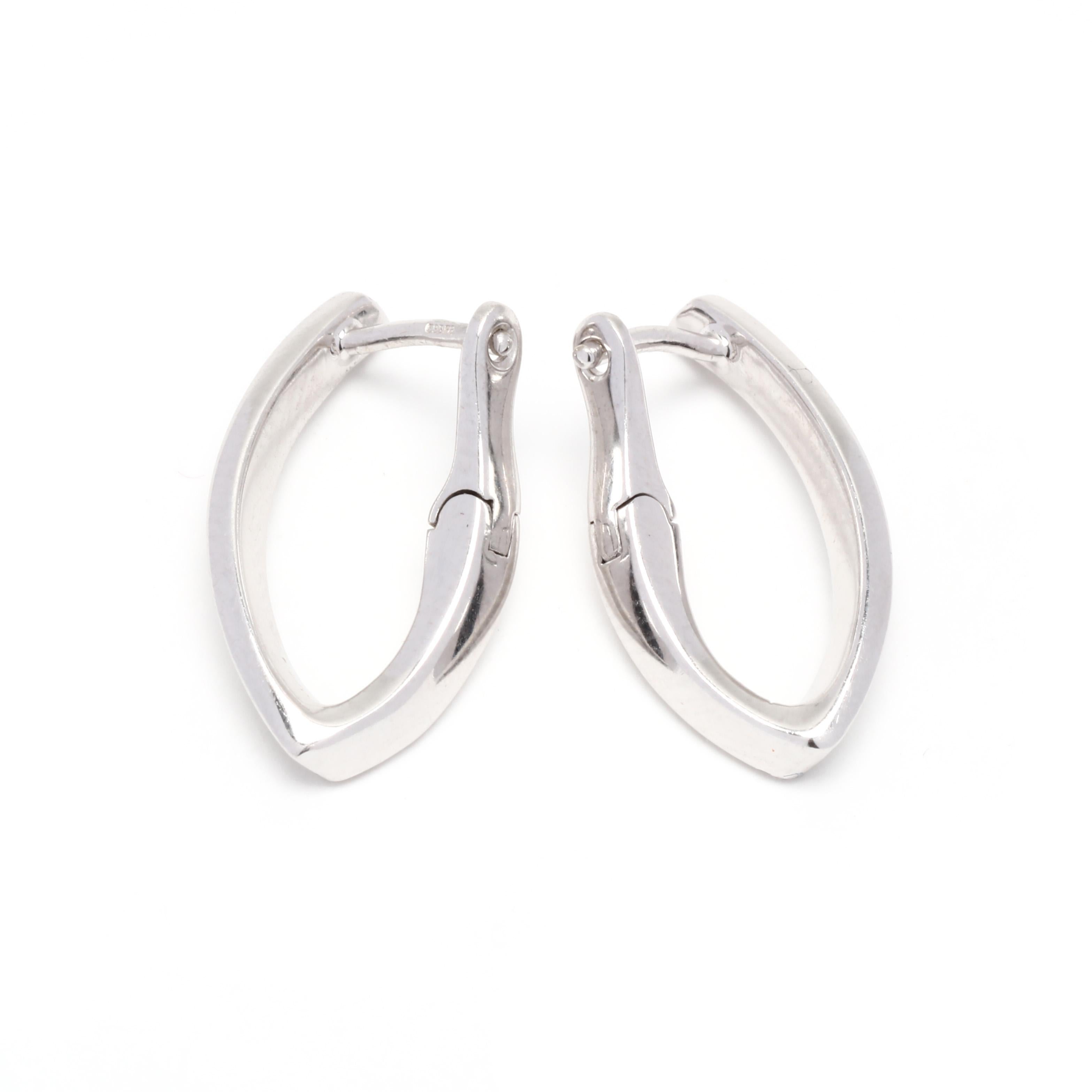 A pair of 14 karat white gold diamond V hoop earrings. These earrings feature a V shape set with full cut round diamonds weighing approximately .32 total carats and with a latch closure.

Stones:
- diamonds, 42 stones
- full cut round
- 1.1 mm
-