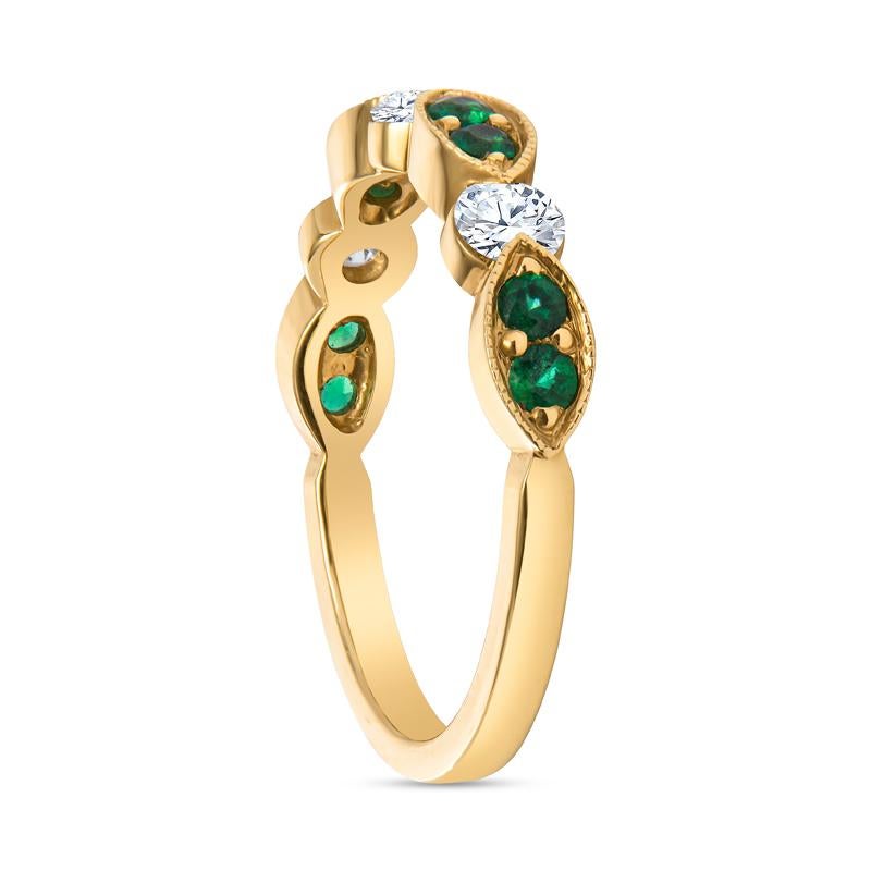 This 18 karat yellow gold band features 0.32 carat total weight in round emeralds set in a milgrain marquise shape. The emeralds alternate with 0.40 carat total weight in round diamonds. It is a size 6.25 but can be resized upon request.